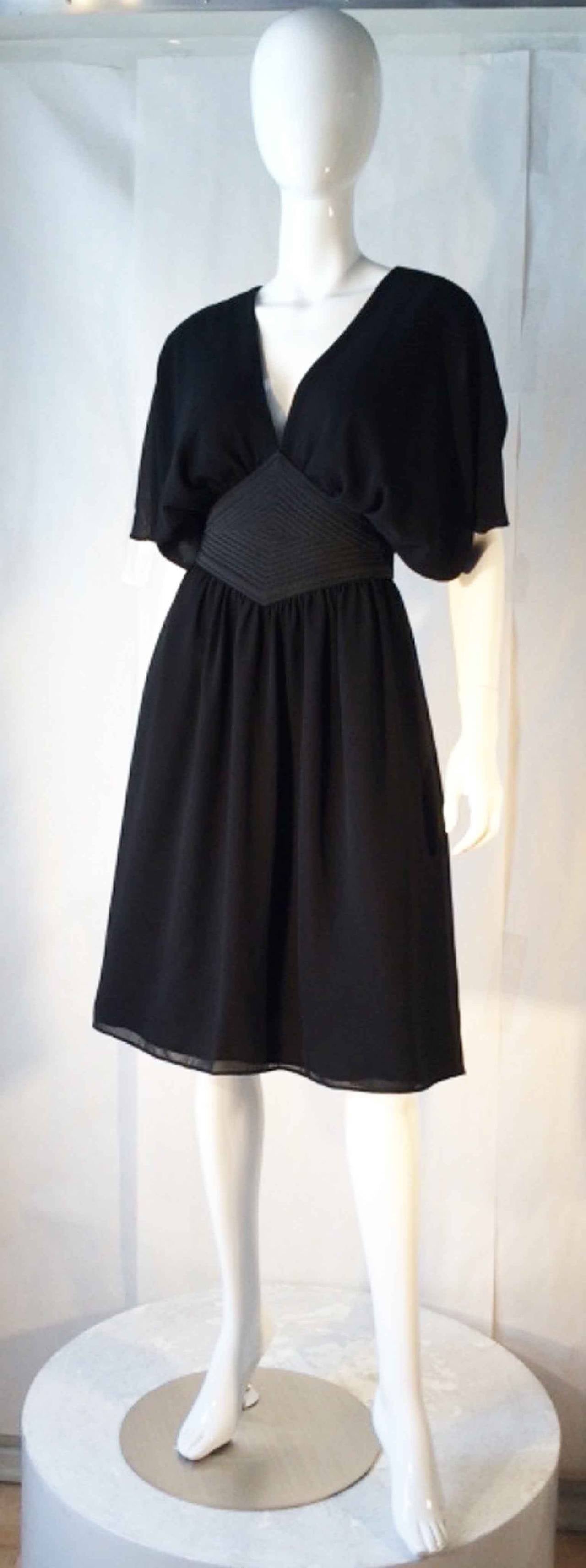 A fine Pierre Cardin cocktail dress. Authentic item features a quilted and sculpted waist band with a double chiffon layer skirt and 