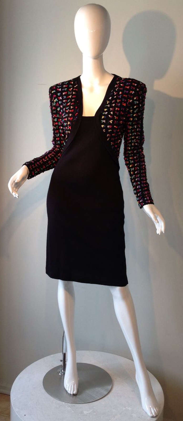 A fine and rare vintage Patrick Kelly cocktail dress. Stretch body conscience fabric item features a trompe l'oeil effect jacket front completely covered in attached miniature silk fabric bows. Item zips up back with built in shoulder pads.