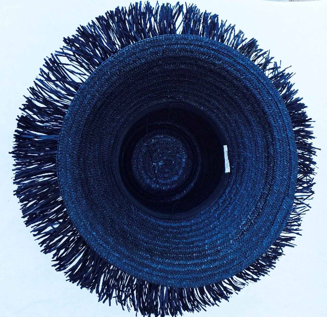 A fine vintage Italian straw beach hat. Black woven raffia straw item features a wide shiny paillettes fringed brim. One size all item. Pristine appears unworn.