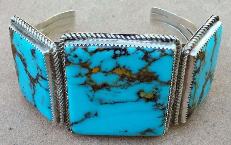 A fine vintage Navajo sterling silver and turquoise cuff bracelet. Authentic old pawn item sourced directly from a old Flagstaff AZ. estate. Signed sterling silver item measures three large polished square stones measuring 1.63 X 1.38