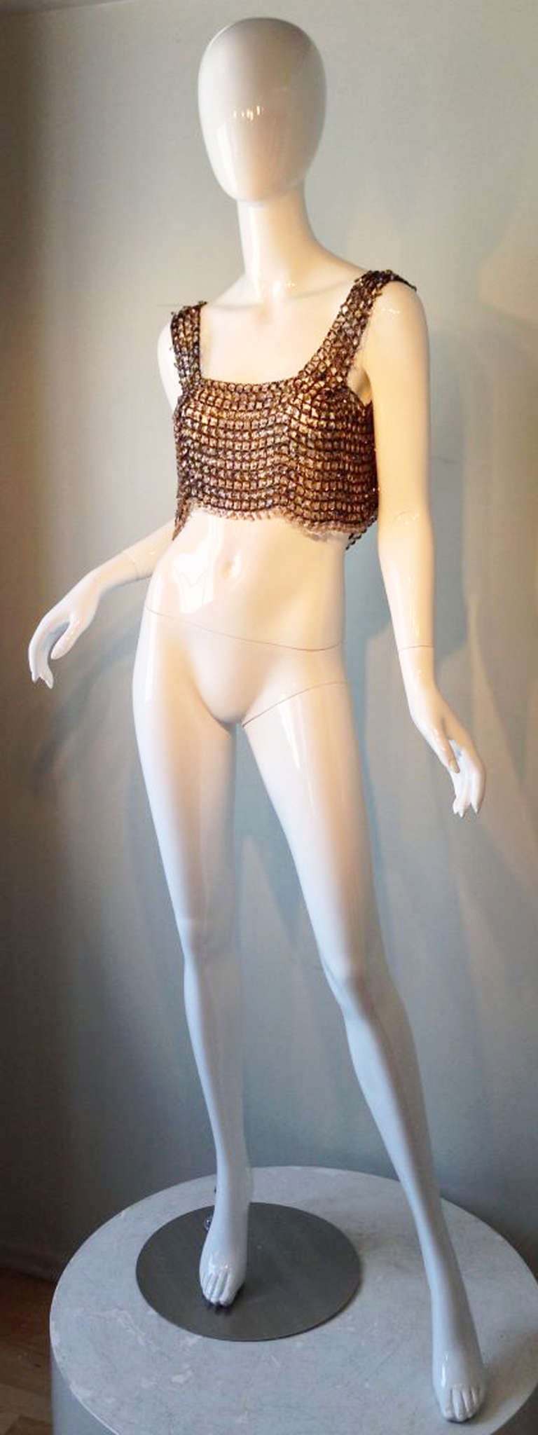 A exquisite and rare vintage Halston crystal chain link evening bodice. Gun-metal chain linked item completely covered in champagne colored crystals. Item features hook back closures back. Unlabeled. Pristine.