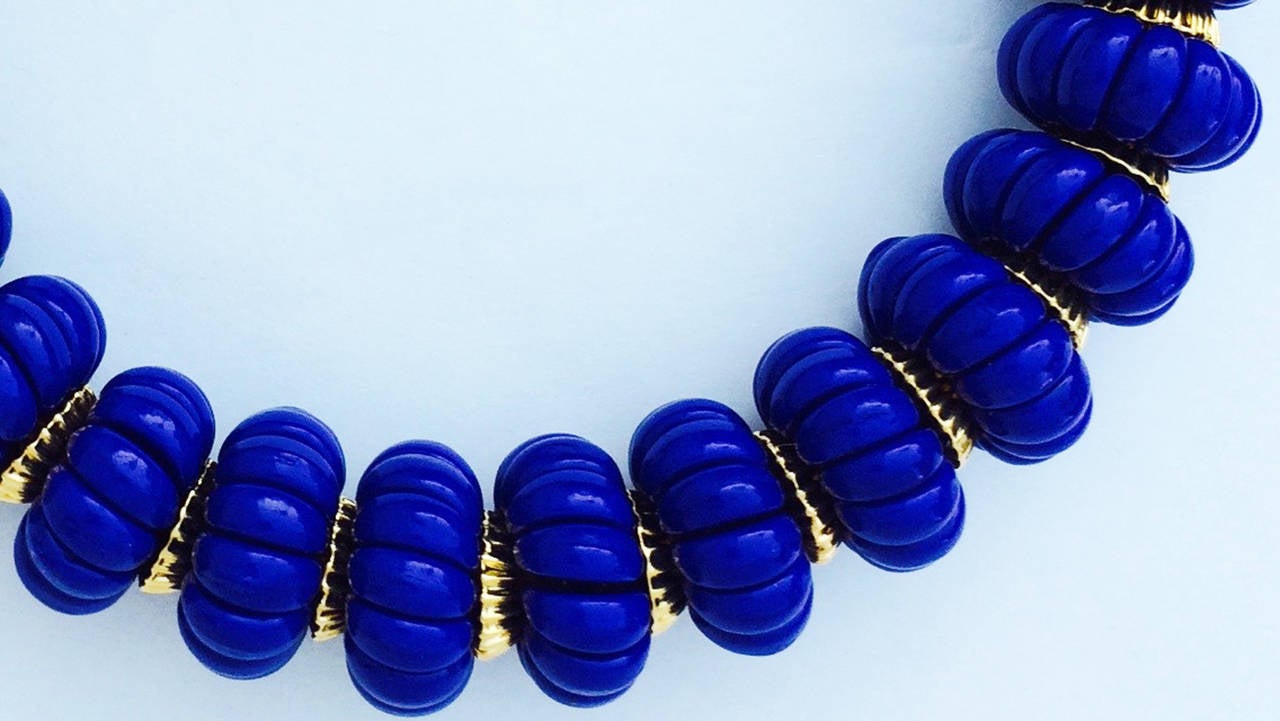 A fine vintage William de Lillo collar necklace. Signed faux carved Lapis bead item with gilt metal spacers and hidden push clasp closure. Pristine and unworn. Matching clip 2
