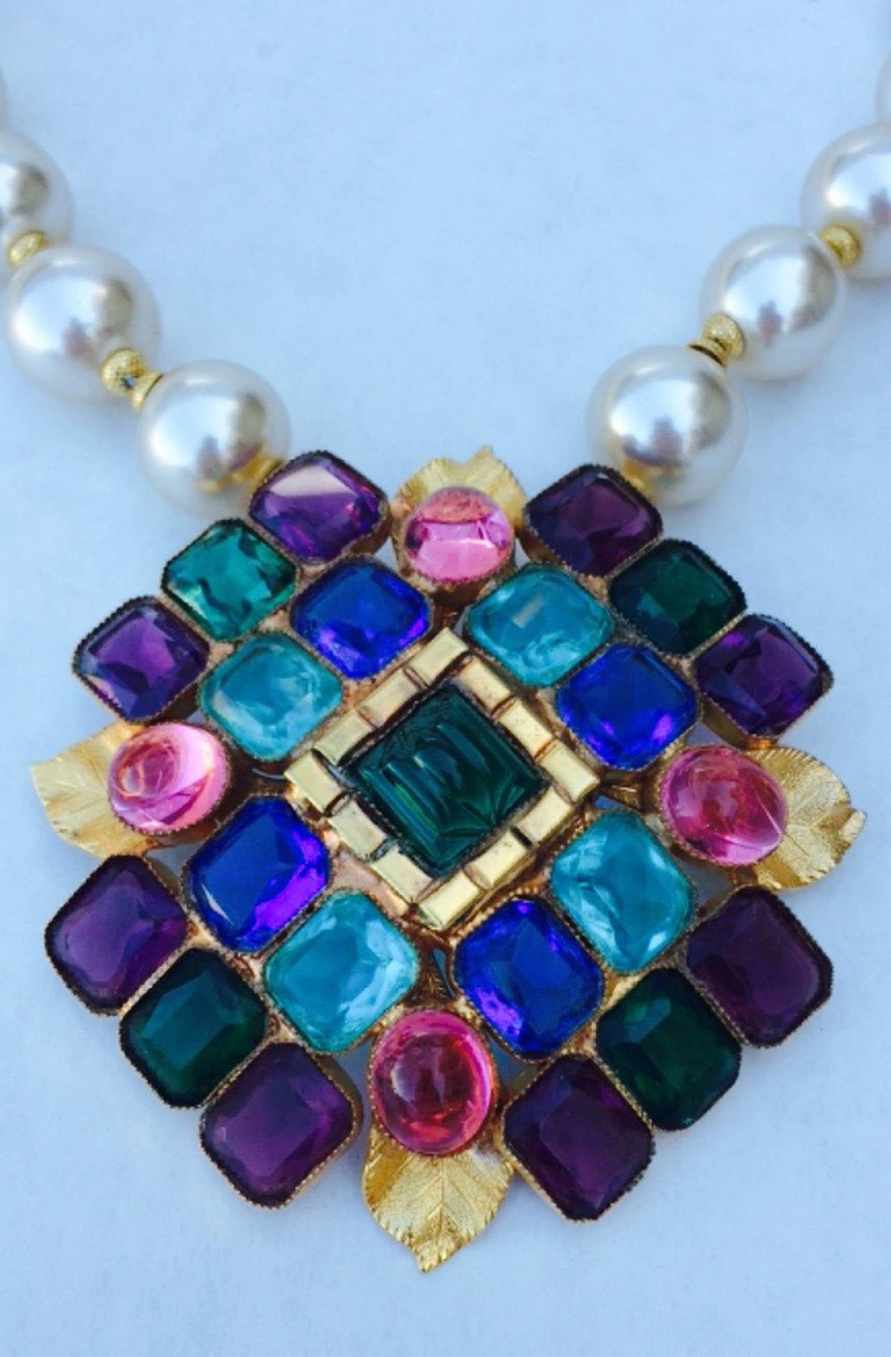 A fine and rare vintage William de Lillo pendant necklace. Signed gilt metal item features multi-color 