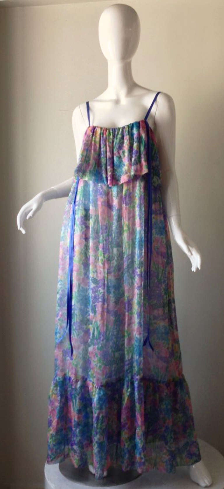 A fine and rare vintage Christian Dior gown. Ethereal floral silk print fabric item features a pleated bodice panel with a matching effect hem. Silk ribbon shoulder straps and matching long ties front and back. Item slips over head (no zipper).