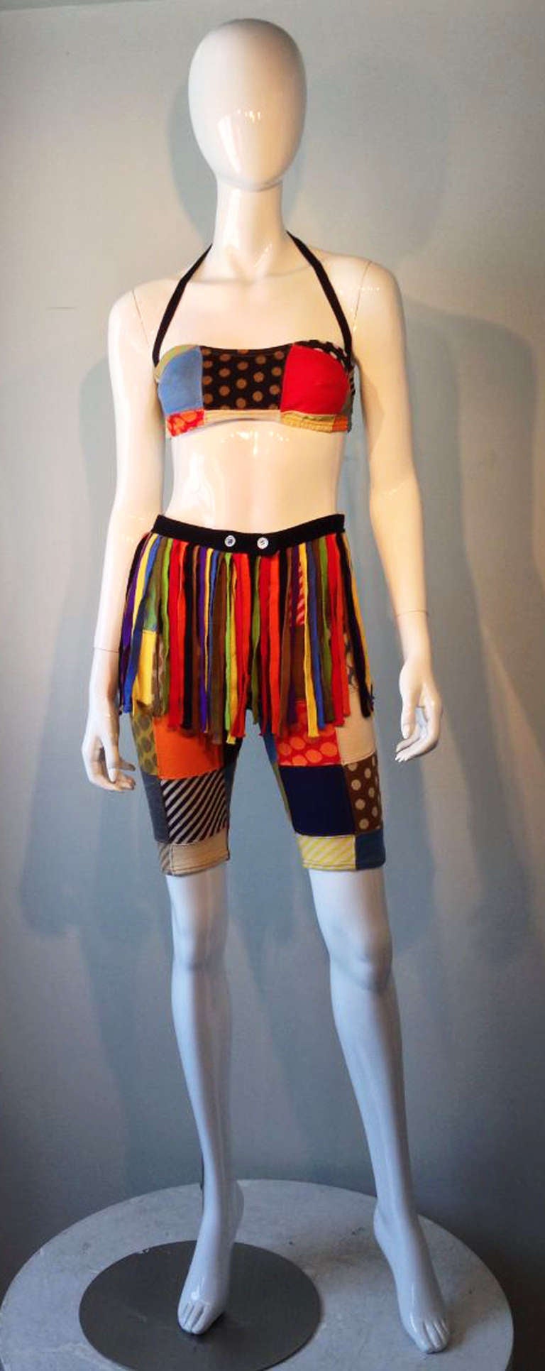 A fine and rare vintage Rudi Gernreich 3pc. swim ensemble. Patch-worked wool knit segments worked into a bandeau top and long shorts. Rare separate fringed waist belt intact and included.