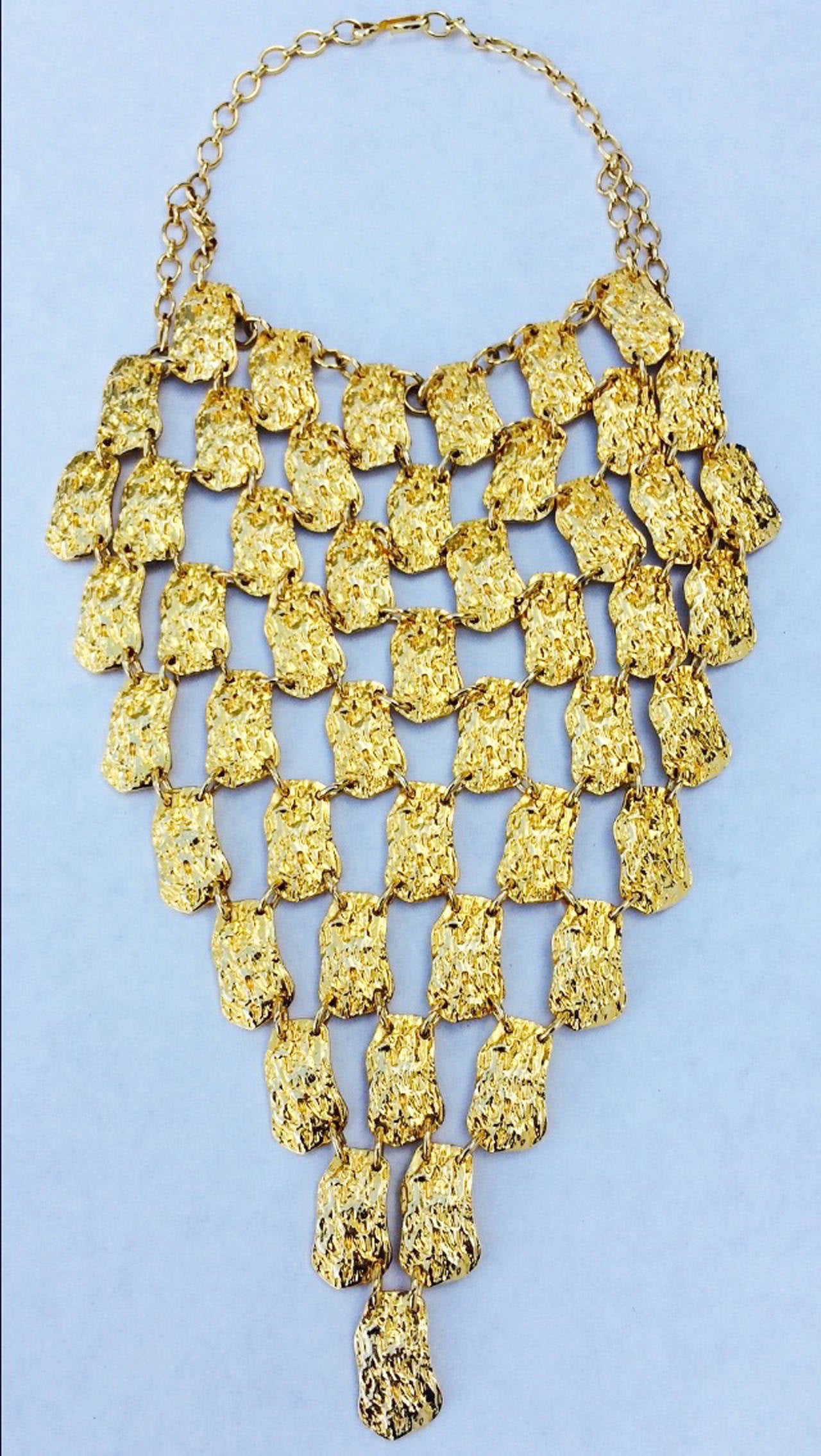 A fine and rare vintage Pauline Trigere bib necklace. Stunning gilt metal linked item features a massive 9