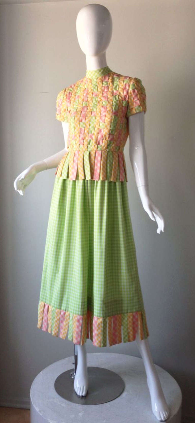 A fine and rare vintage Donald Brooks braided gingham dress. Charming alternating yellow, pink and green cotton gingham fabric woven to create bodice front and short sleeves. Matching 