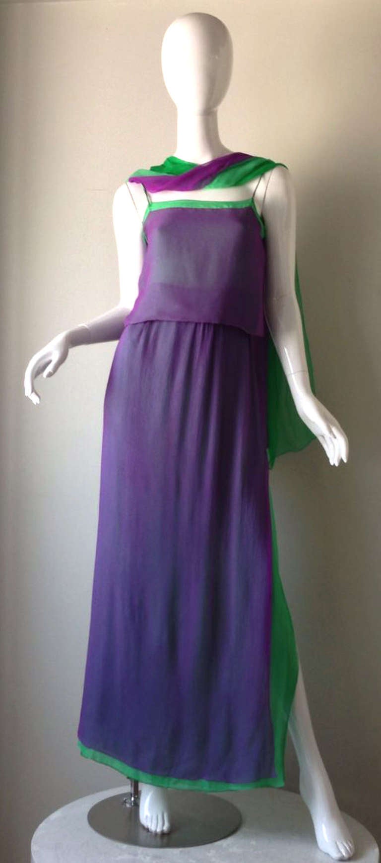 A fine vintage Pauline Trigere 2pc. chiffon gown plus matching wrap. Exquisite etherally layered chiffon (amethyst over emerald green) items fully silk lined. Bodice features shoulder straps, full length skirt features deep vents back side. Original