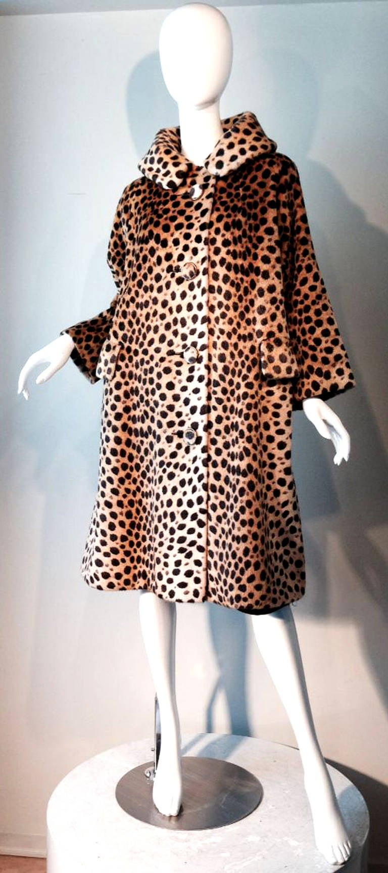 A fine and rare vintage Dan Millstein faux leopard fur coat. Exquisite printed faux fur item fully lined with matching fabric covered button front closures, large stand-up collar and side pockets (one size fits S/M/L). Pristine.