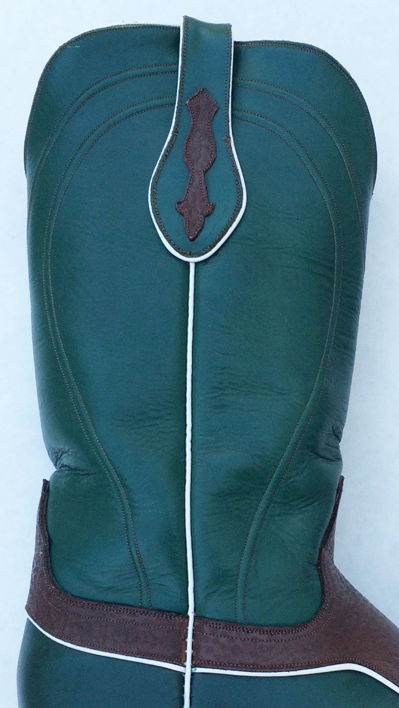 A fine vintage pair gents Ammons custom leather and kangaroo cowboy boots. Exquisite hand cut and pieced leather items including lining, soles and heels. Rich supple dark green with brown kandaroo and white leather trimmed items feature original