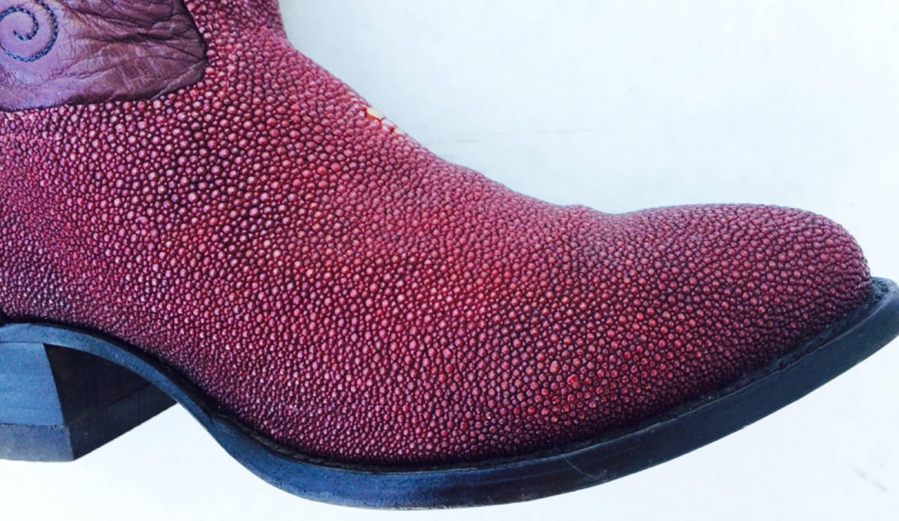 A fine vintage pair Tony Lama stingray cowboy boots. Authentic burgundy leather items feature stingray skins, decorative stitching, leather soles and heels. US mens size 10 1/2D. Excellent rarely worn from a dry climate.