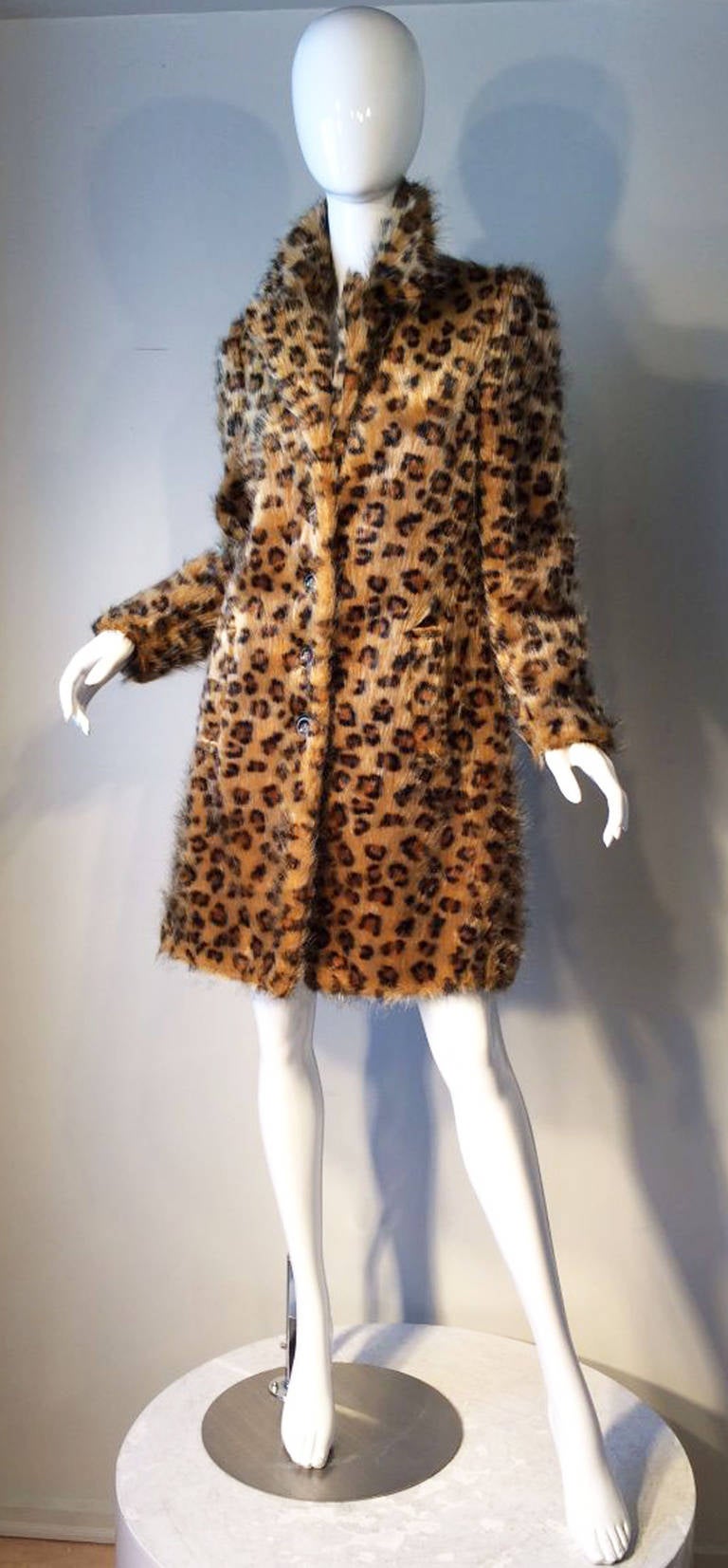 A charming vintage Betsey Johnson faux leopard fur coat. Printed synthetic fiber item fully lined with button front closures and side pockets. Pristine appears unworn.