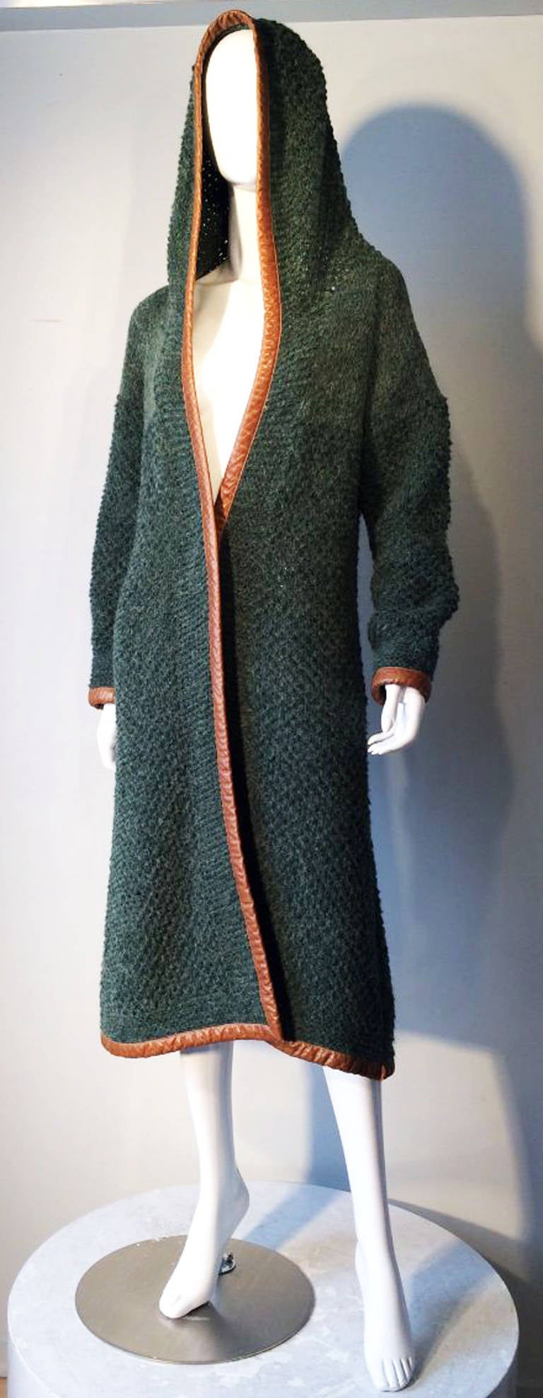 A fine vintage Gucci hooded knit wrap. Authentic greens alpaca/mohair blend knit item fully trimmed in calf leather. Two tone item features a open front (no closures) and built in hood with a 54