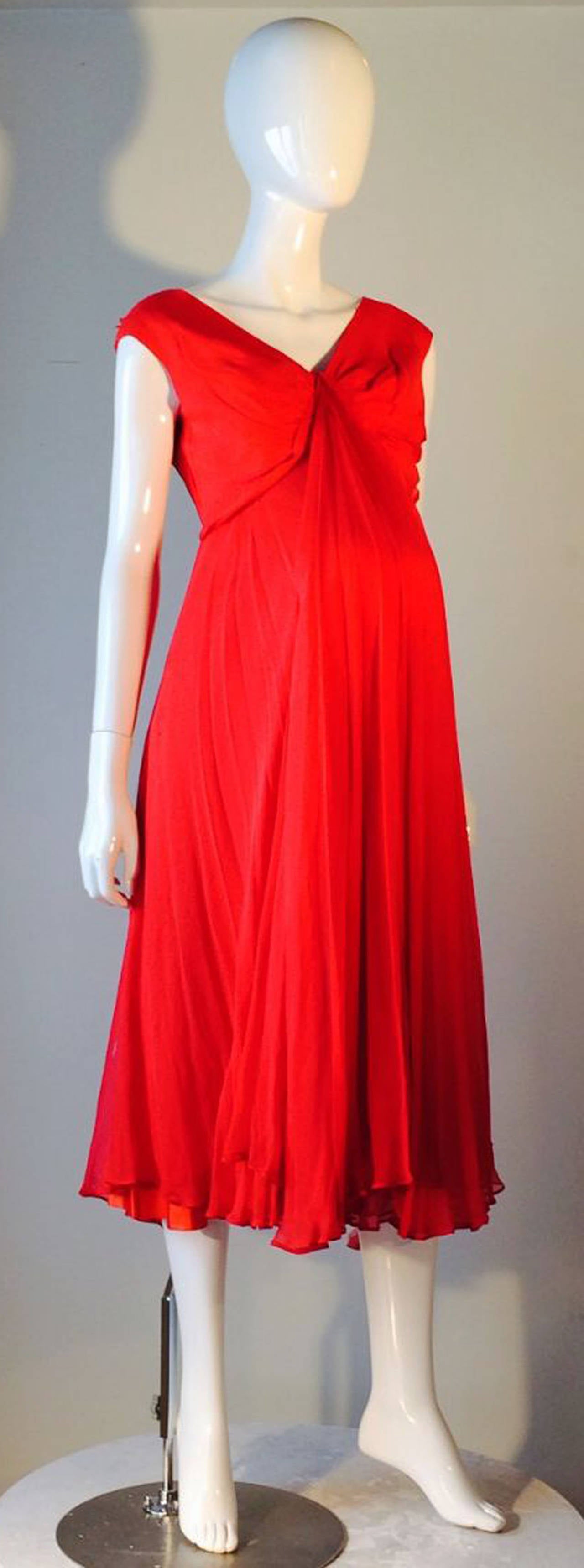 A extremely rare vintage red silk chiffon maternity cocktail dress worn by former First Lady, Jackie Kennedy. Dress worn during John F. Kennedy Jr. pregnancy, 1960. Item previously sold thru Julien's Auctions (Jan 15, 2007 lot 736). Dress mentioned