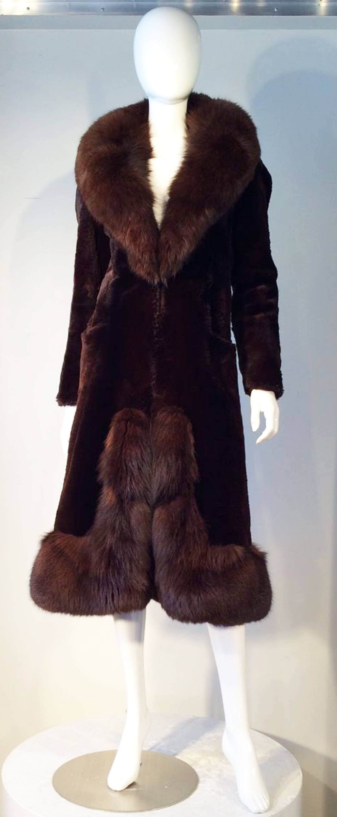 A fine and rare vintage Christian Dior sheared beaver fur coat. Item features matching color (rich dark brown) fox fur collar and trim. Coat features a nipped waist, hidden side pockets, fully silk lined and hidden hook closures. Excellent condition.