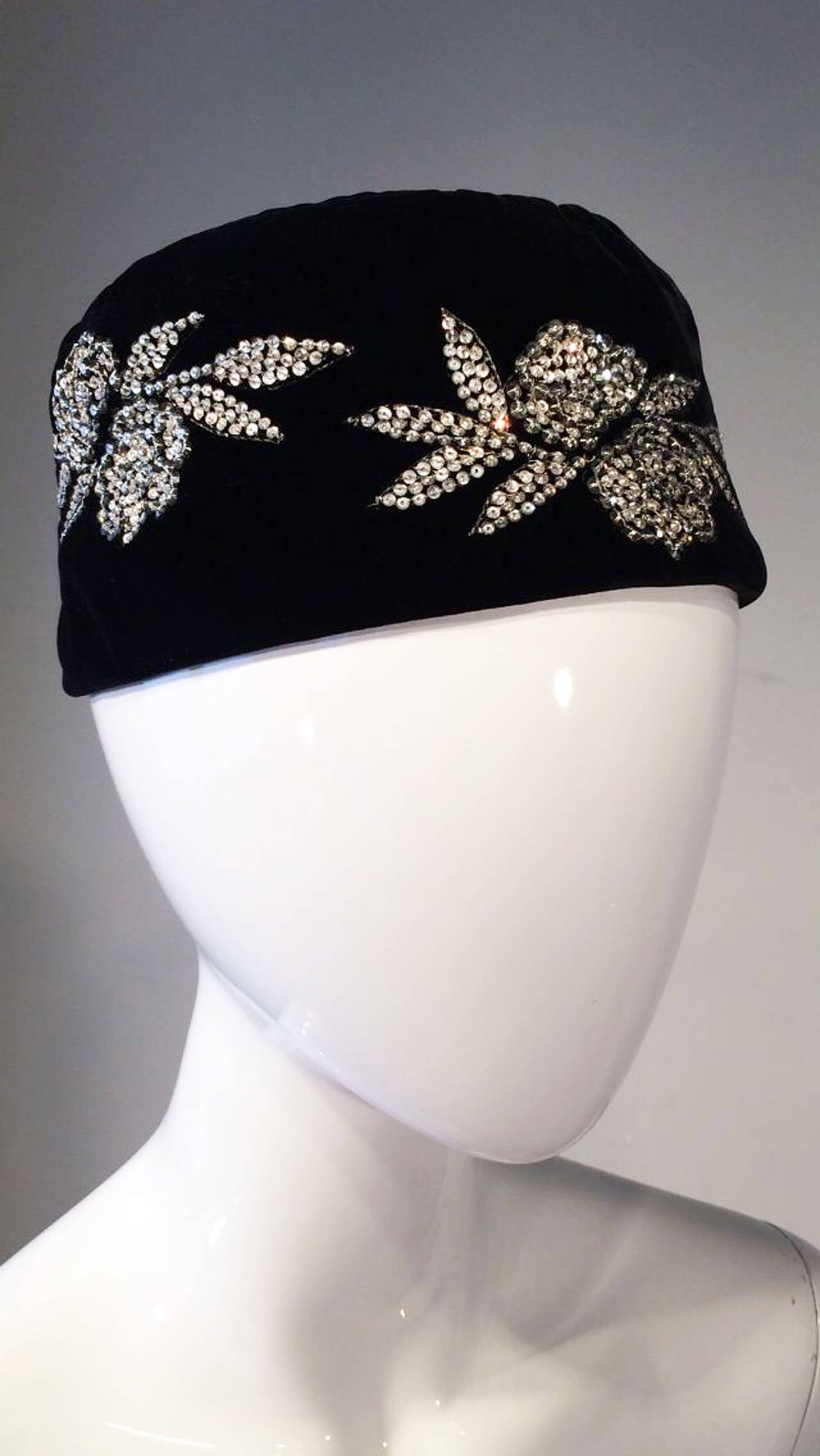 A exquisite Valentino evening cap. Jet black silk velvet item embroidered with crystal floral details. Item fully silk lined with original hang tag intact. Unworn.