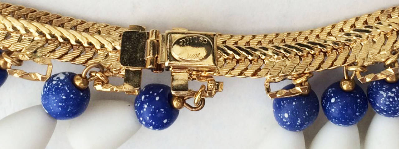 A fine and rare vintage William de Lillo collar. Signed gilt metal snake chain item features white glass and faux Lapis pendant drops and hidden push clasp closure. Non-produced one-off sample item from the Wm de Lillo archives. Unworn.