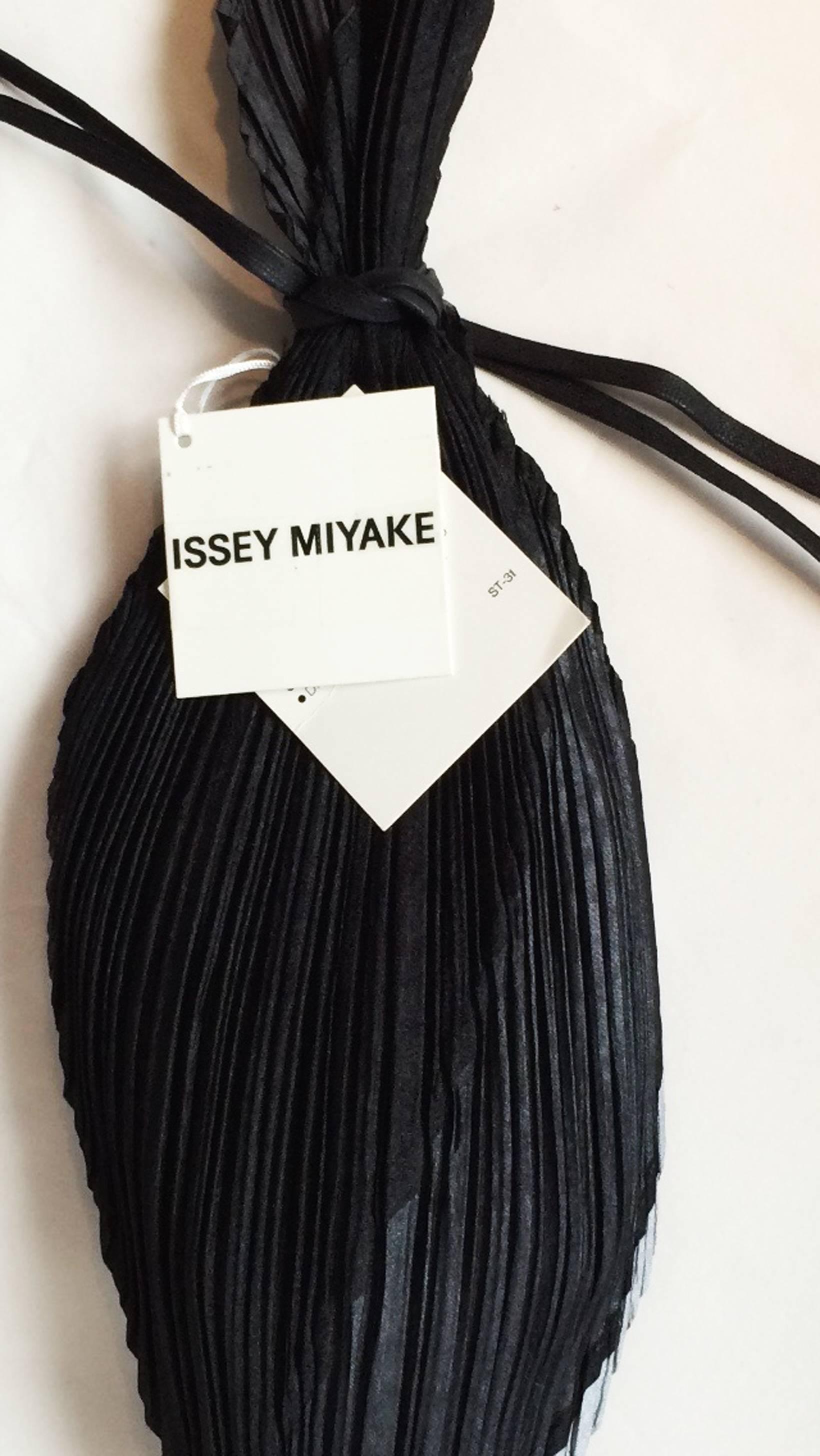 A fine vintage Issey Miyake miser's pouch handbag. Authentic sculpted jet black/gray pleated fabric item with drawstring closure. Original hang tags intact. Pristine.