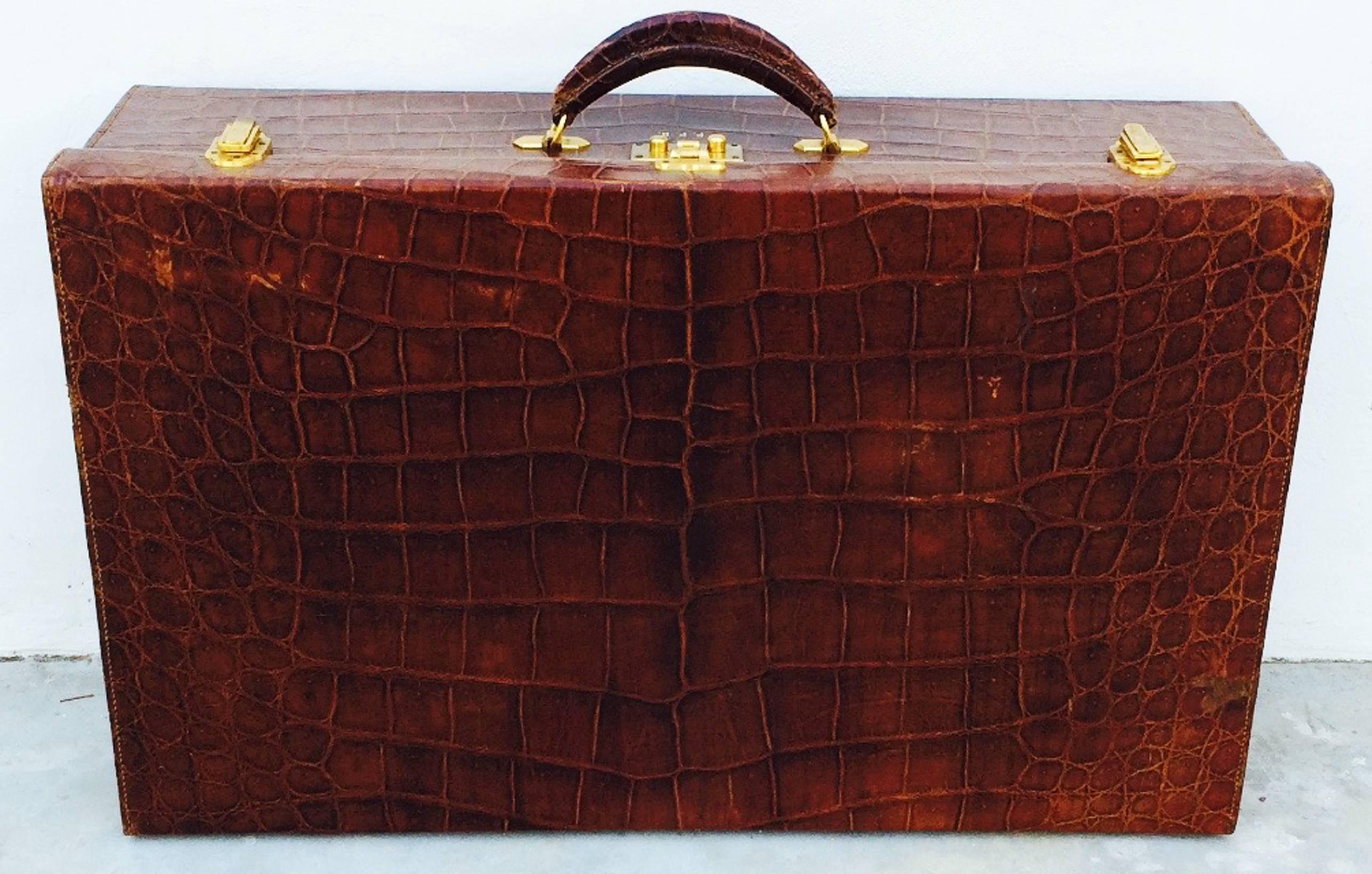 A extremely rare Hermes crocodile travel case/suitcase. Exquisite seldom seen item features matched skins exterior with original gilt gold hardware and glides (no key). Item retains original finish with a few random scuff marks etc. Corners and