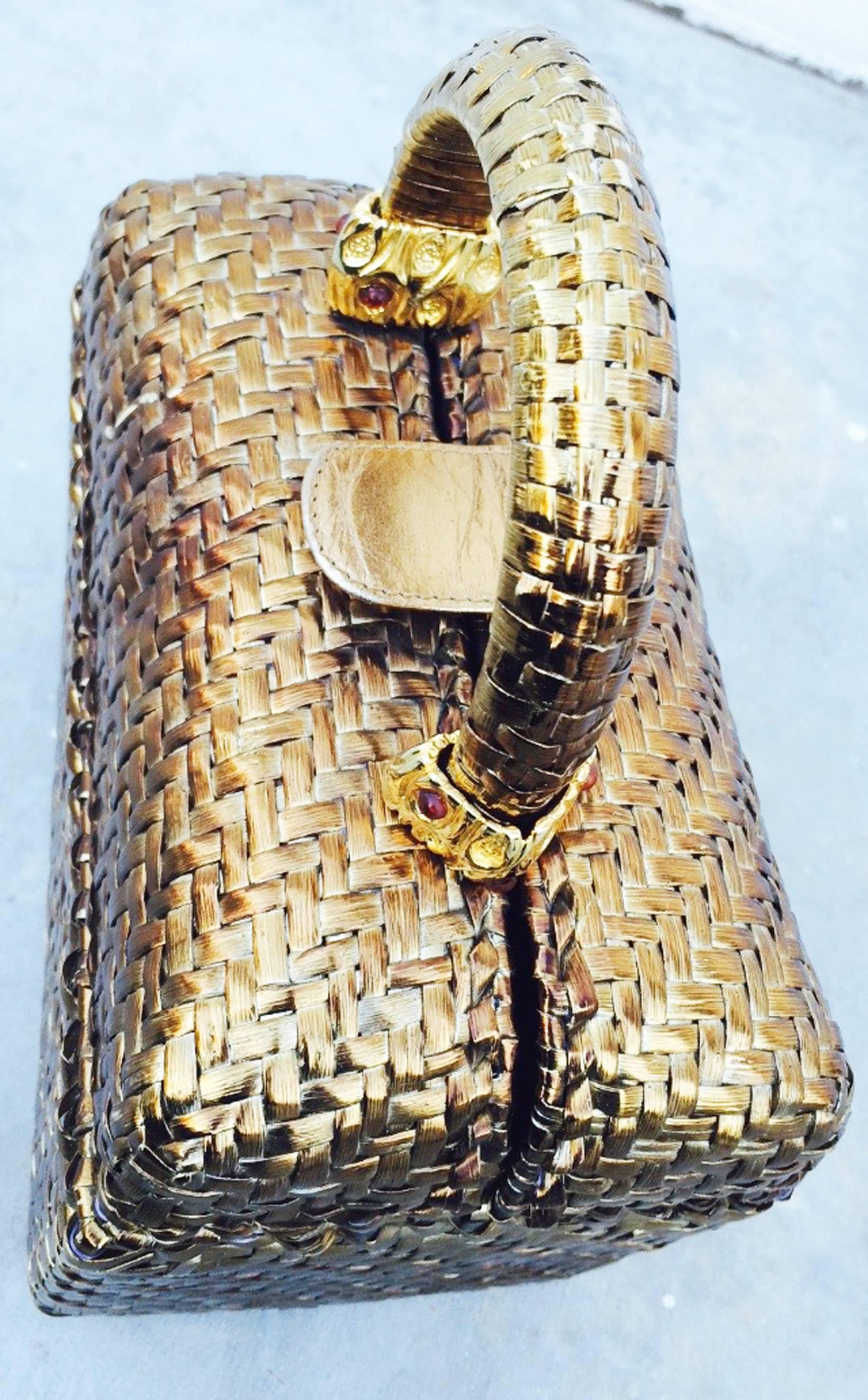 A fine vintage Rodo wicker evening handbag. Gilt gold lacquered woven wicker item features a leather covered snap closure, gilt metal hardware and black vinyl lined interior. Bag includes a 2.75