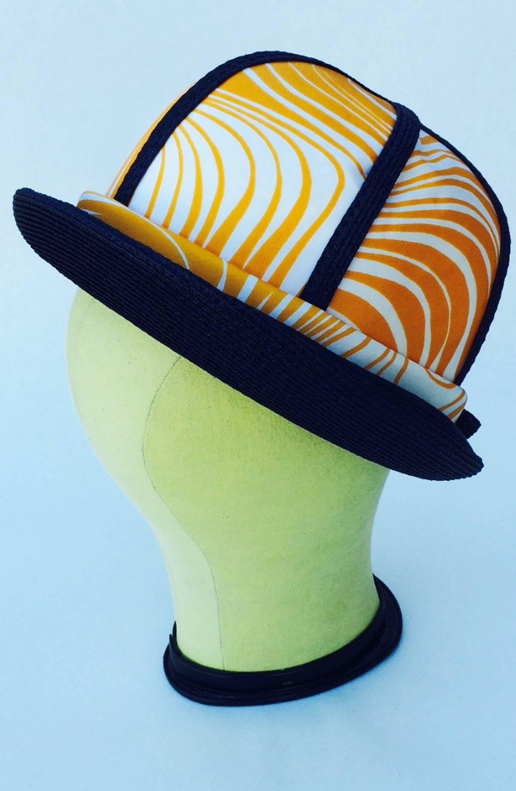 A fine vintage Oleg Cassini bowler hat. Authentic mod period print item trimmed in navy raffia and fully silk lined. Pristine appears unworn