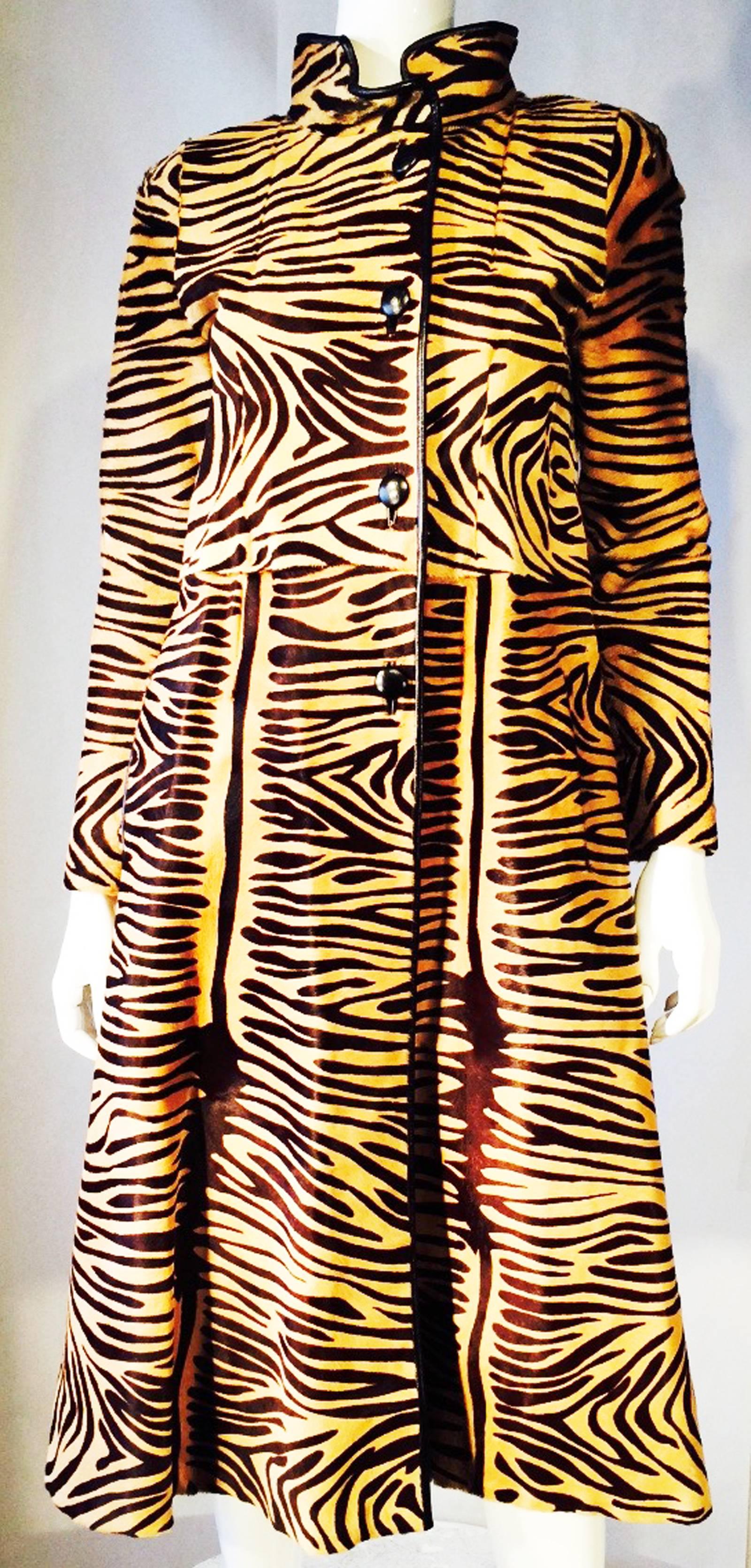 A fine and rare vintage Christian Dior couture pony hair coat. Hand-printed tiger stripe item features precision seam panel construction and black leather welted trim with hidden side pockets. Item includes US fur registration label and 1950s era I.