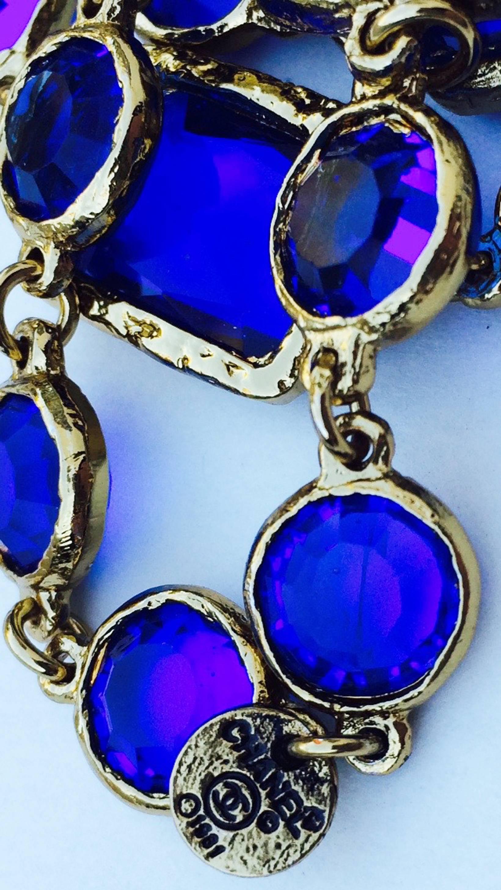 A fine vintage Chanel blue crystal sautoir necklace. Authentic signed gilt metal link item features both 