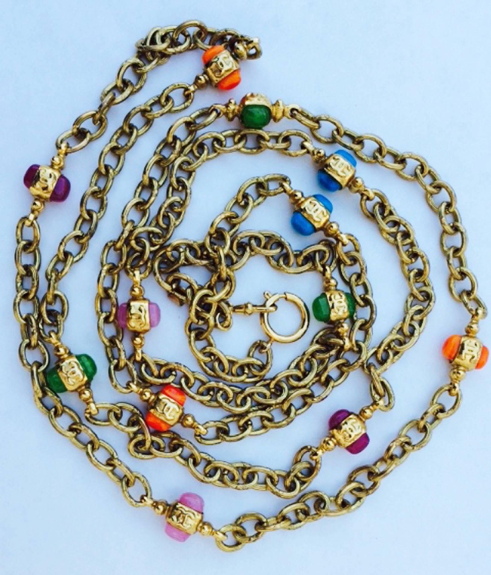 A fine and rare vintage Chanel sautoir necklace. Signed gilt metal chain linked item features poured glass stations and original locking clasp. Excellent with no issues.