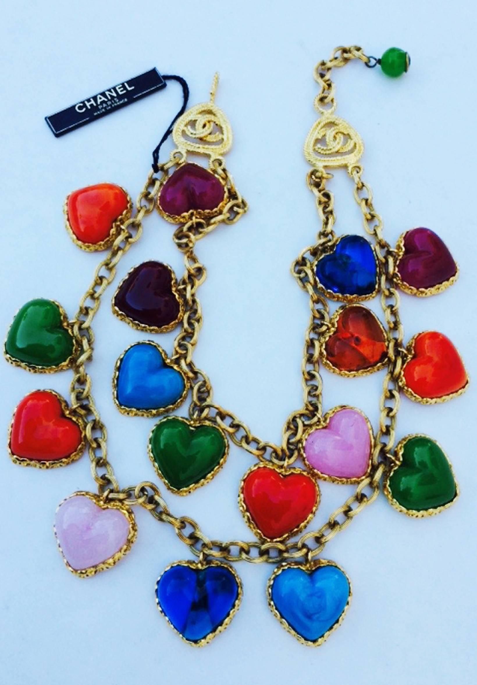 A fine and rare vintage Chanel bib necklace. Signed gilt metal double chain and bezel item features multi-color Maison Gripoix poured glass hearts. Item retains original hook closure and Chanel hang tag. Pristine unworn item.