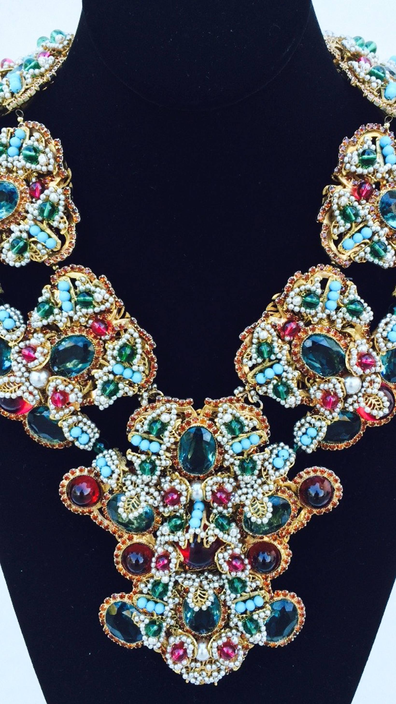 A incredible one-off William de Lillo maharani mughal style bib necklace. Signed gilt metal item features glass, metal and crystal stones/elements (layer upon layer including green, ruby, turquoise,red, faux pearl etc.). Rare one-off hand