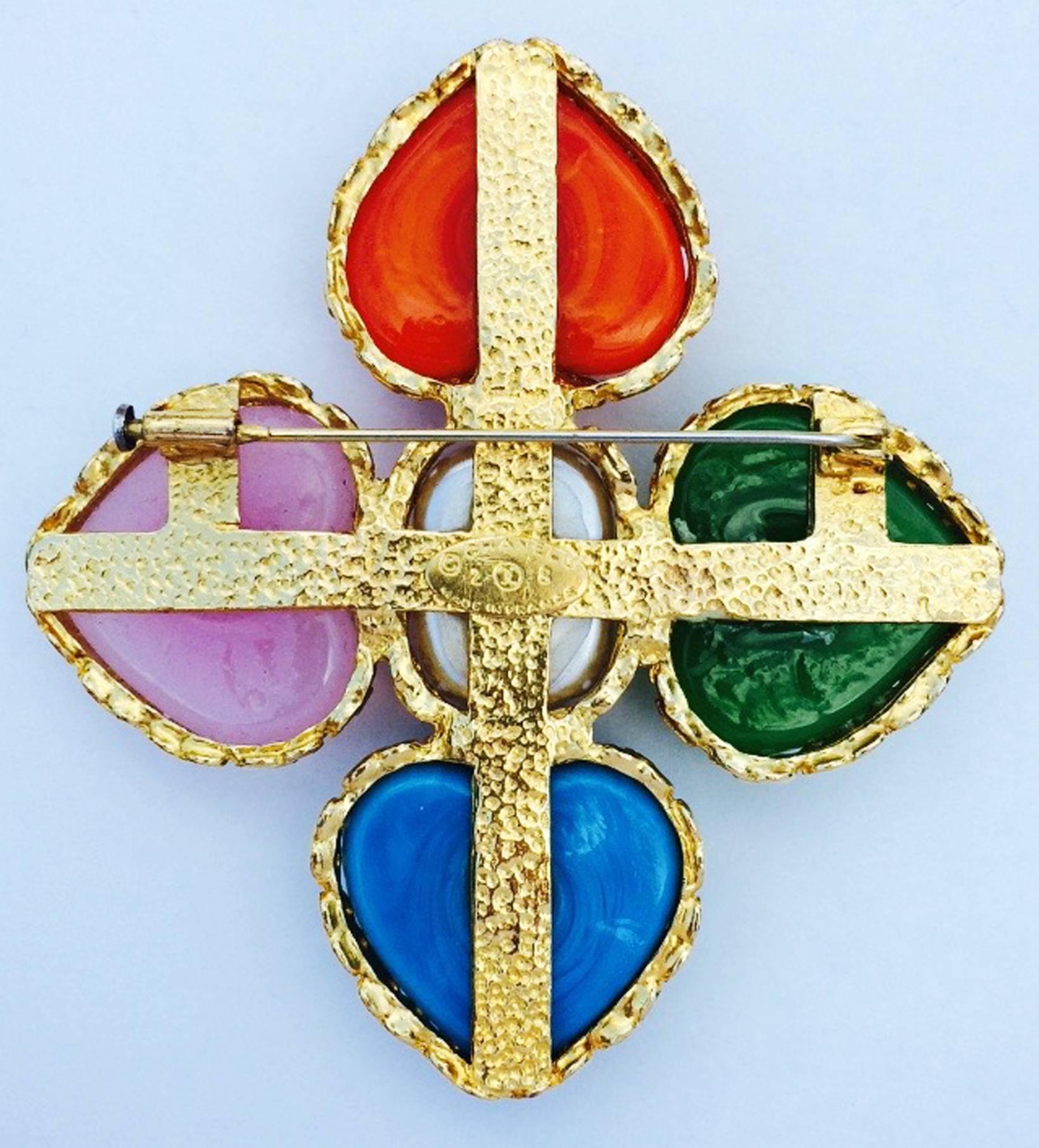 A fine and rare vintage Chanel hearts cross brooch. Signed gilt metal item features a faux pearl center and various colored Maison Gripoix poured glass 