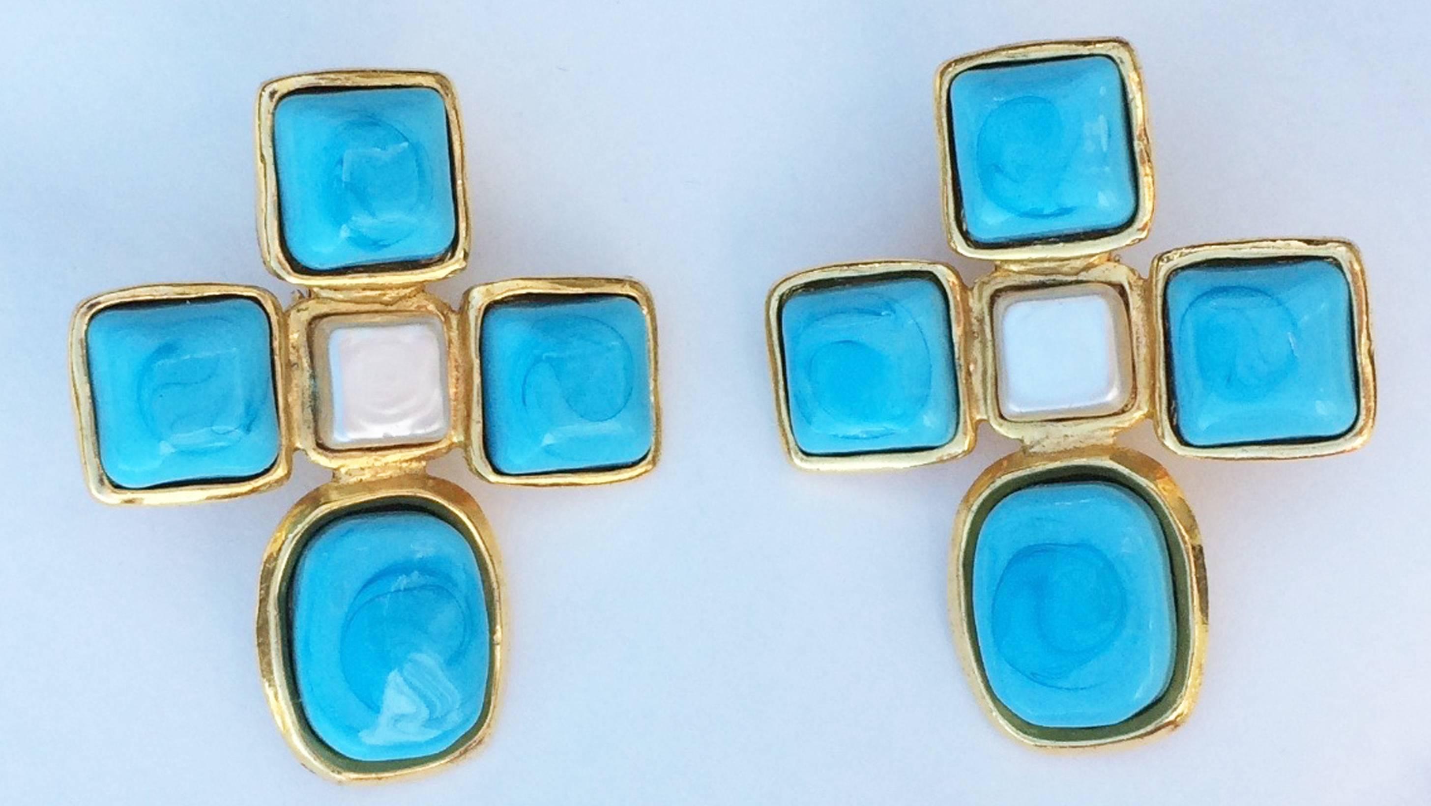 A fine vintage pair Chanel ear clips. Signed gilt metal items feature faux pearl centers and vibrant turquoise blue Maison Gripoix poured glass 
