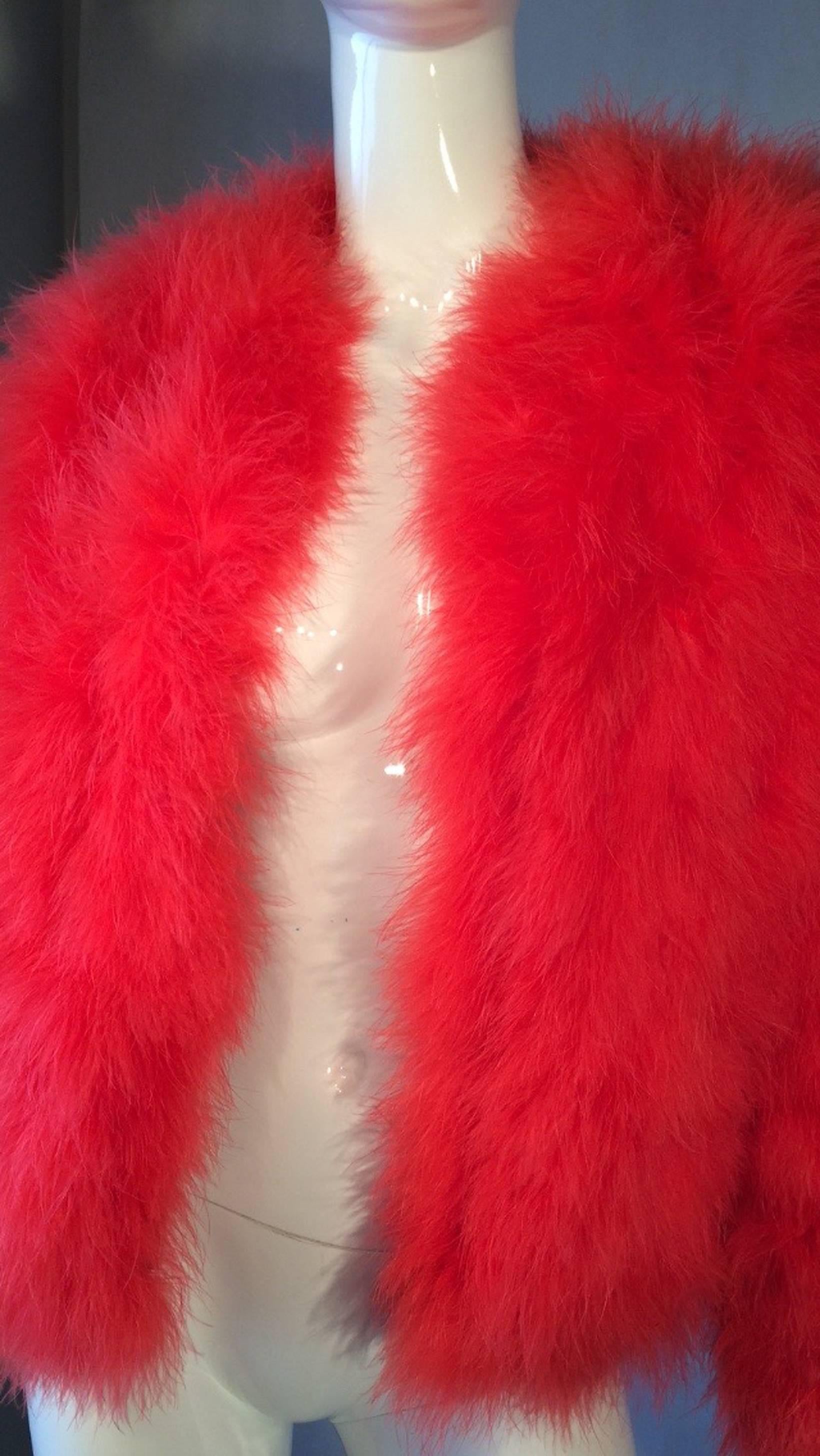 A fine and rare vintage Donald Brooks feather jacket. Authentic persimmon dyed marabou feather item fully lined in a pop art printed white and black jersey knit. Item features a open front (no closures). Excellent with no issues.