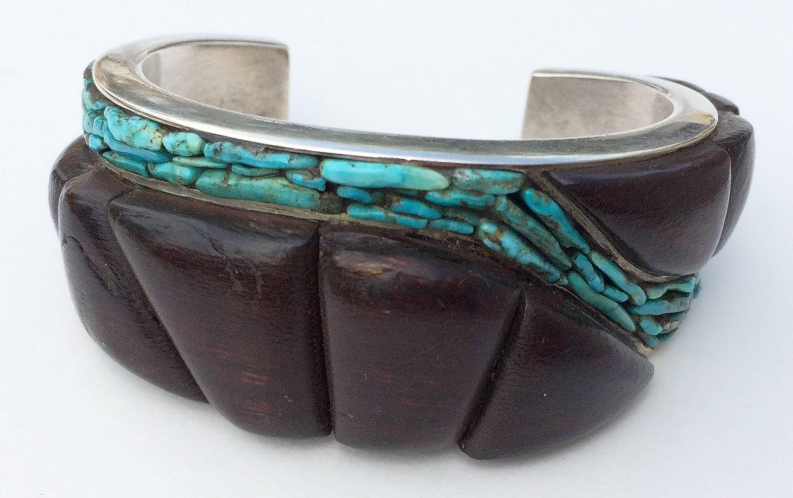 A fine and rare Paul Durkee studio modernist cuff bracelet. Signed sterling silver item features channel set carved and polished ironwood and turquoise nuggets in a free form organic setting. Outstanding design and execution. 1.25