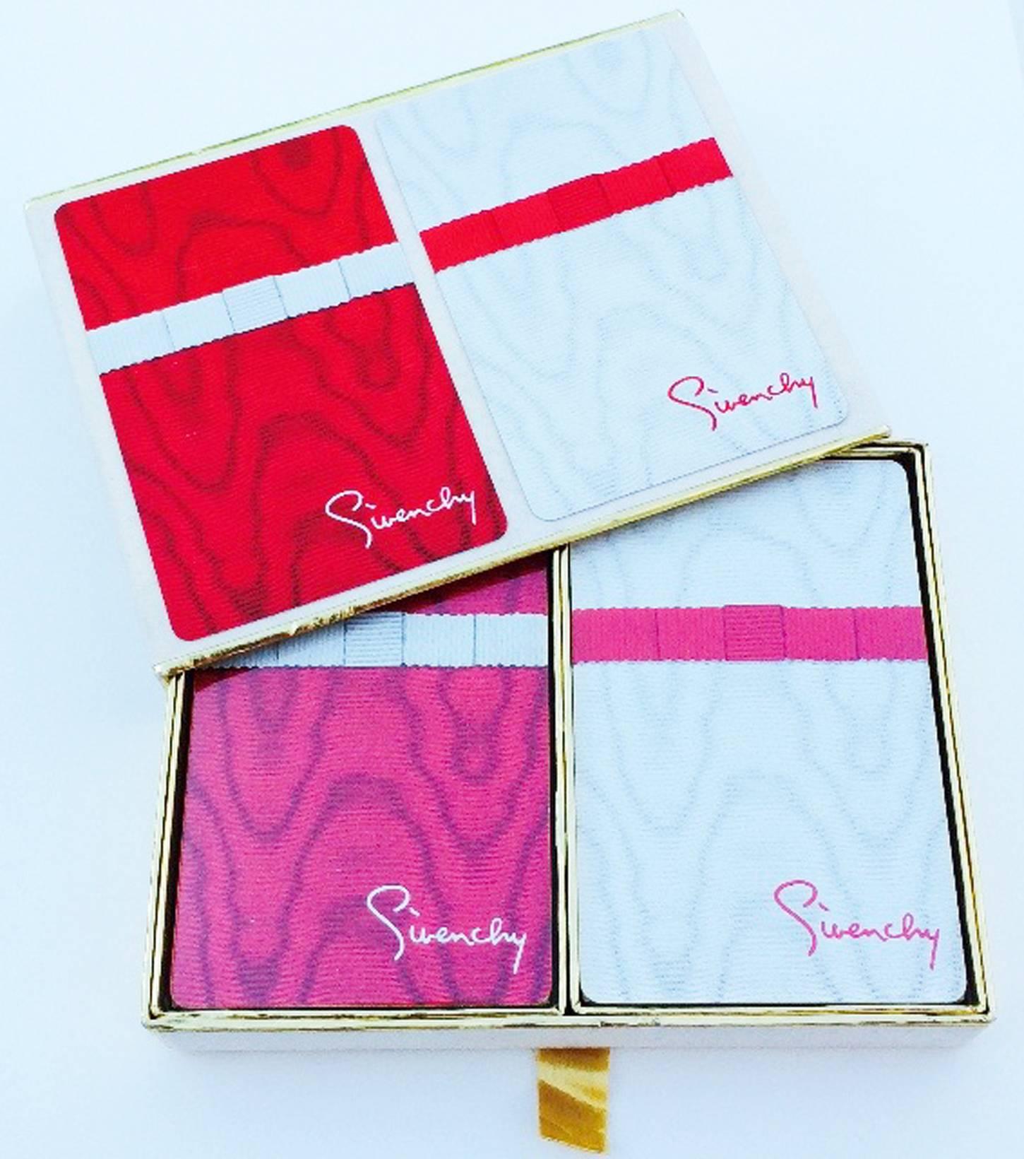 A fine pair Givenchy playing/poker cards. Double printed decks of cards with original signature box. Card sets pristine and unopened. 