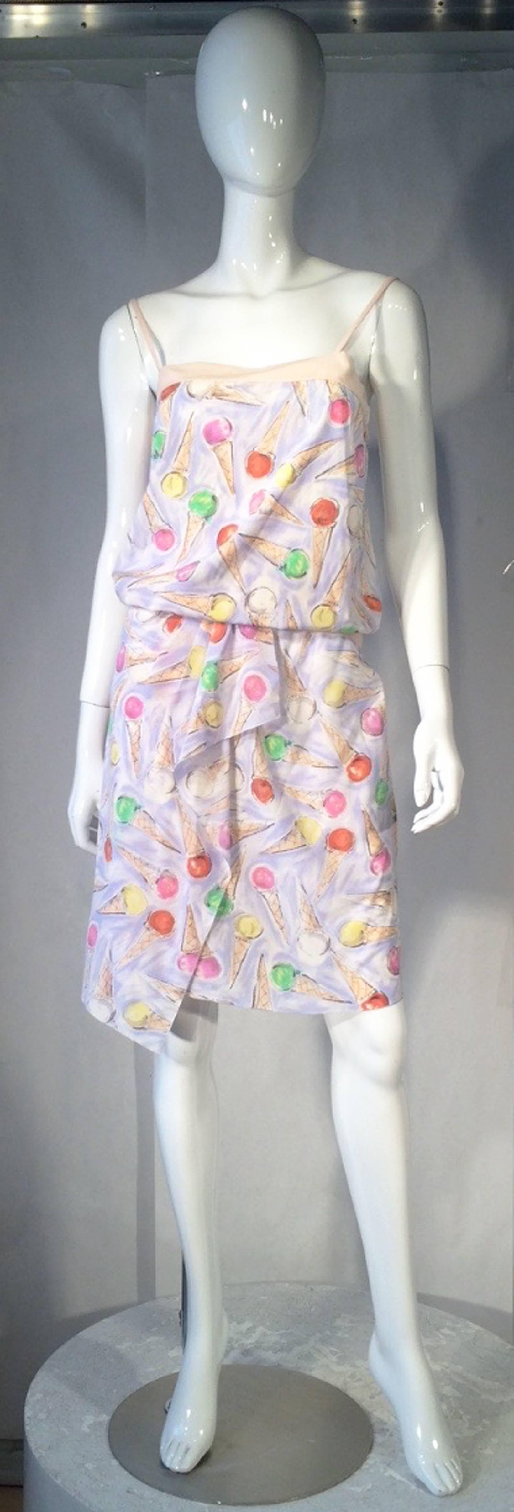 Iconic Chanel ice cream print 2pc. dress (Cruise collection, 2004). Silk crepe print items include a tank top (slips over head) and matching draped front skirt (buttons up back). Both items trimmed in a nude colored crepe. Pristine appears unworn.