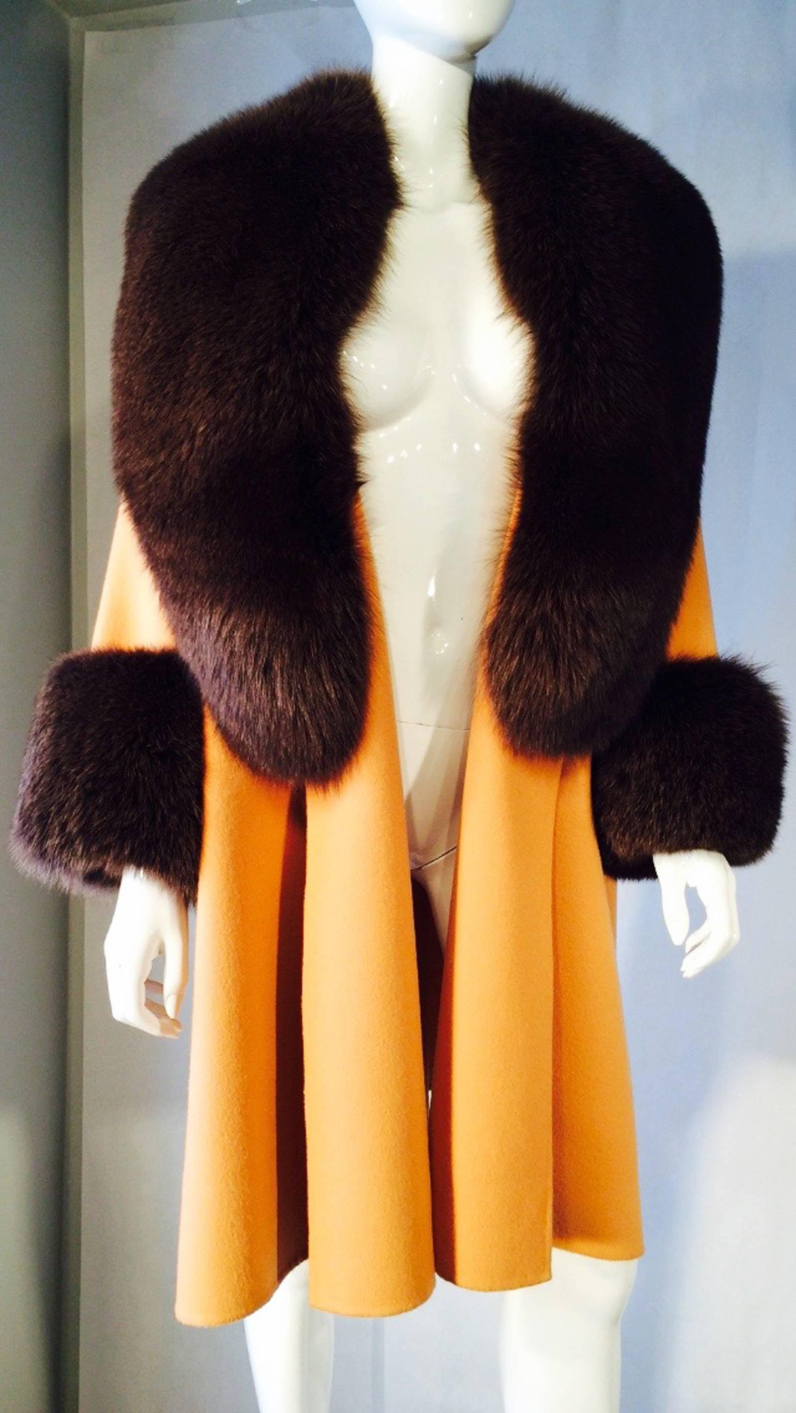 A exquisite vintage John Anthony couture fur trimmed swing coat. Double faced melon wool coat with thick luscious green over brown dyed fox fur collar and cuffs. Item fully lined with a open front (no closures). A fantastic one-off American