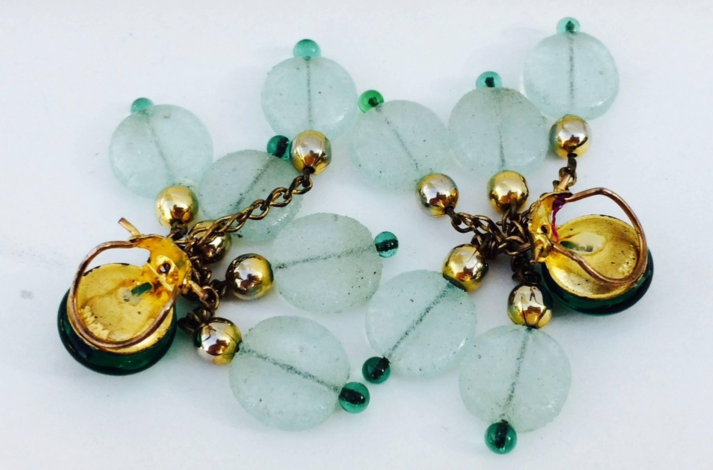 A fine vintage pair Maison Gripoix ear drops. Rare gilt metal items feature vivid green glass cabochons with etched seafoam green glass and gilt beaded fringed chains. Items retain original clip backs. Excellent.