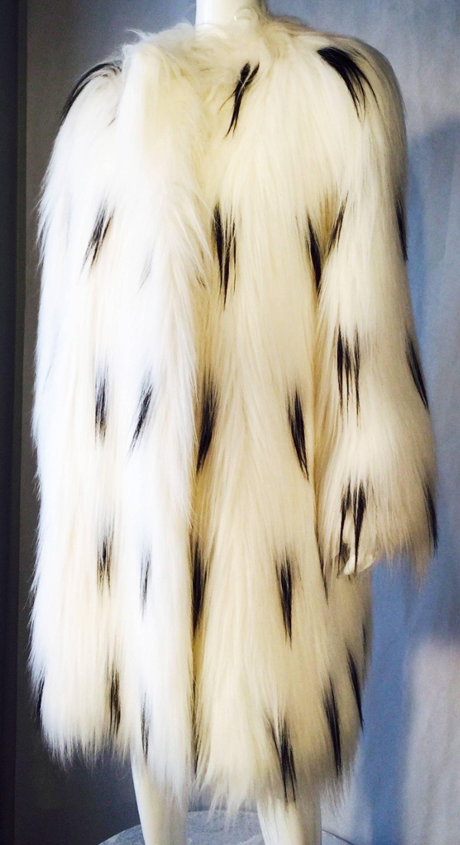 A fine and rare vintage Pauline Trigere faux monkey fur coat. Long pure white faux fur item with additional black 