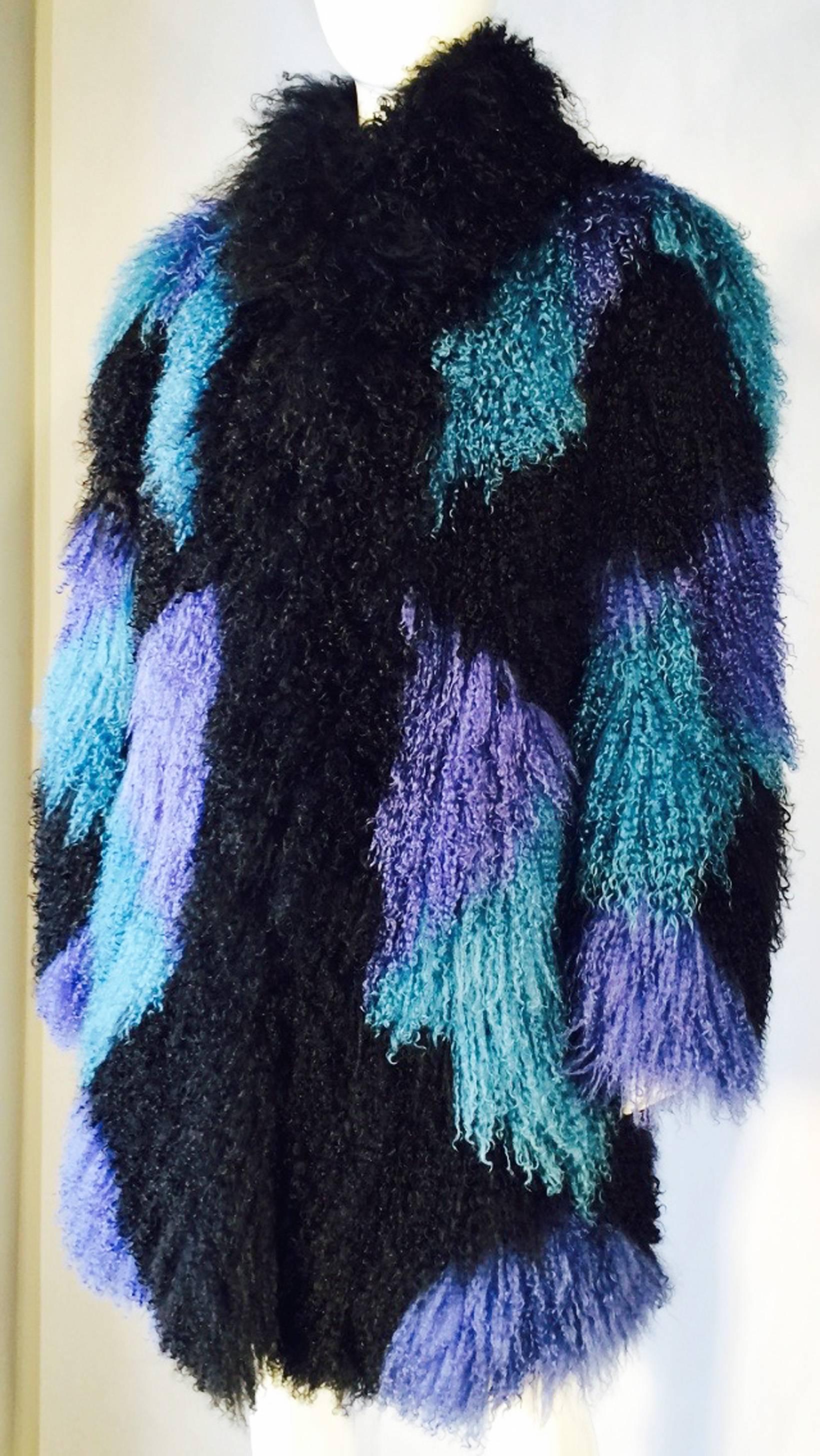 A fantastic vintage Mongolian lamb fur coat. Dynamically dyed and pieced fur item in green, amethyst and black fur. Impressive item fully silky lined with a hidden hook front closures. Pristine with no issues.