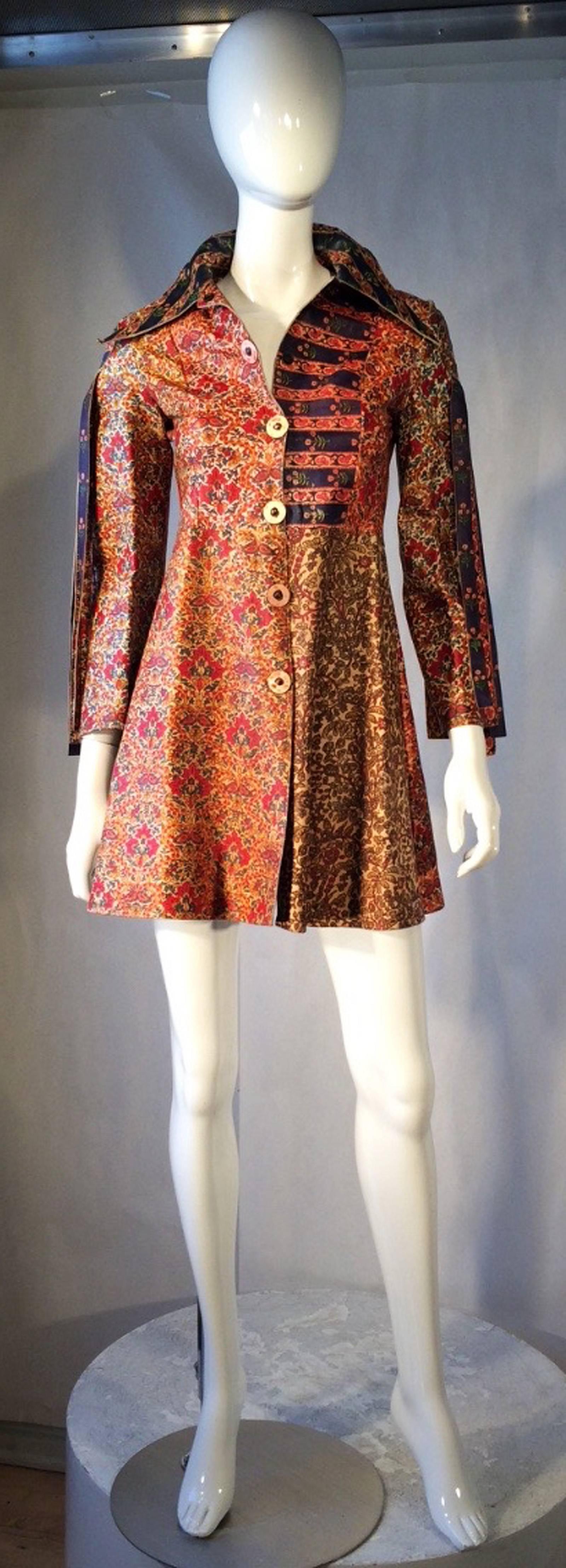 A fine and rare vintage Roberto Cavalli printed leather mini dress. Authentic hand decorated patchwork leather item features applique medallions at shoulder sides and back center. Medallions secure three (3) long matching fringes at each point. Item