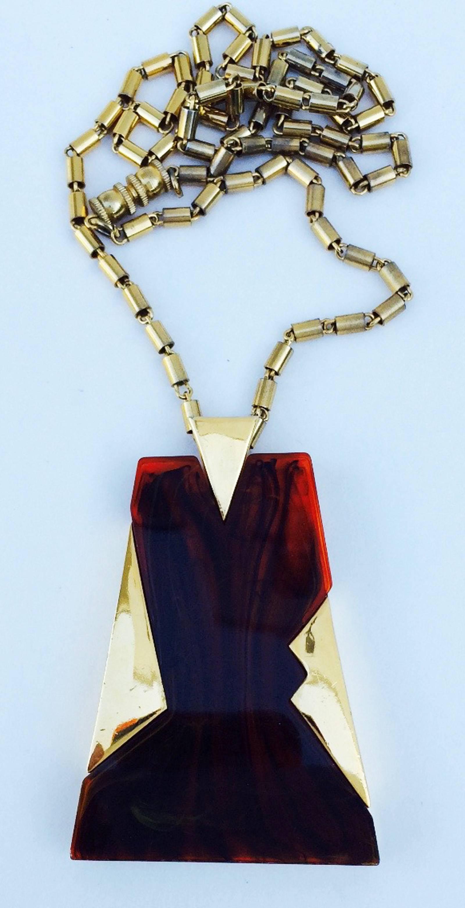 A fine and rare vintage Trifari Lucite pendant necklace. Signed gilt link item features a Lucite 