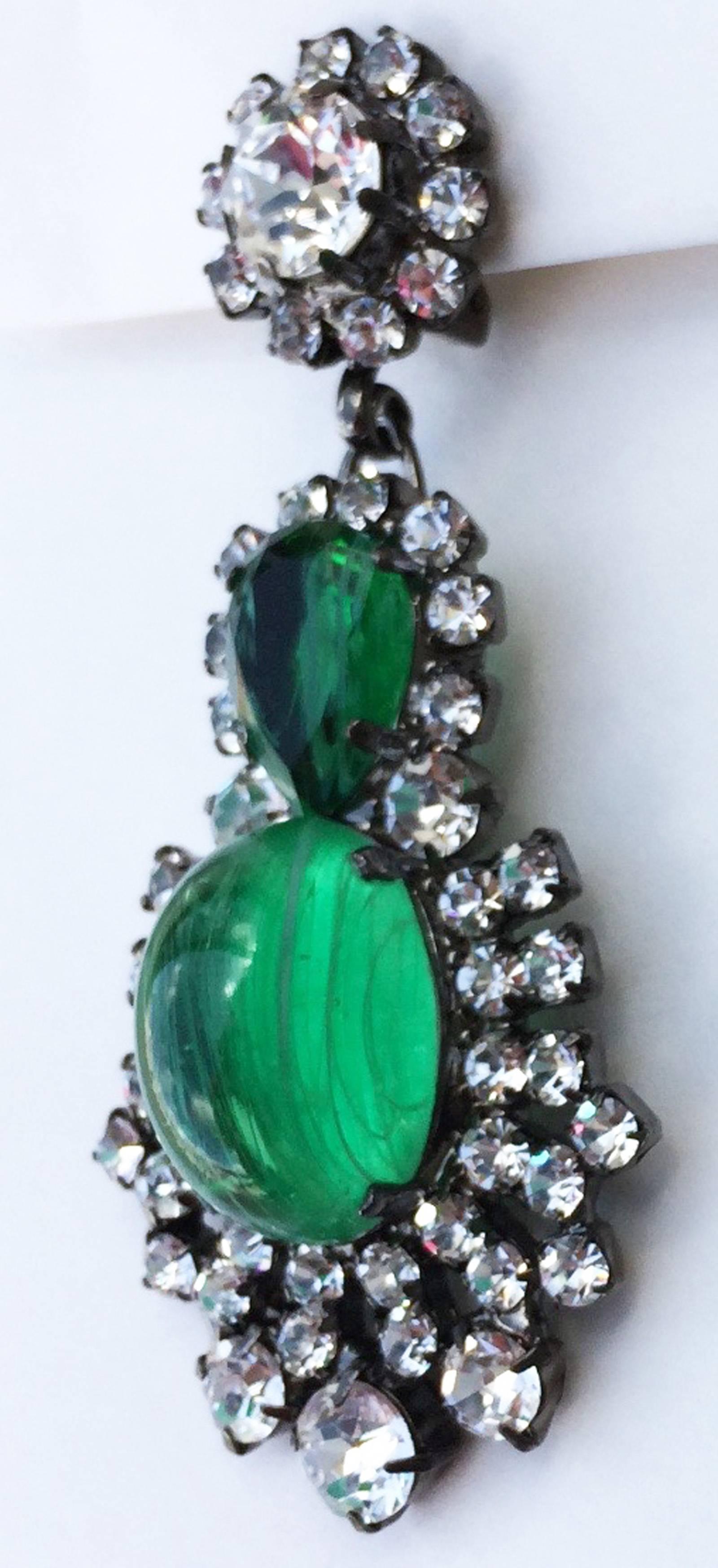 A fine pair Alan Anderson crystal ear drops. Signed japanned metal items feature molded green glass centers, faceted green crystal stones and Swarovski crystals. Clip backs. Pristine unworn.