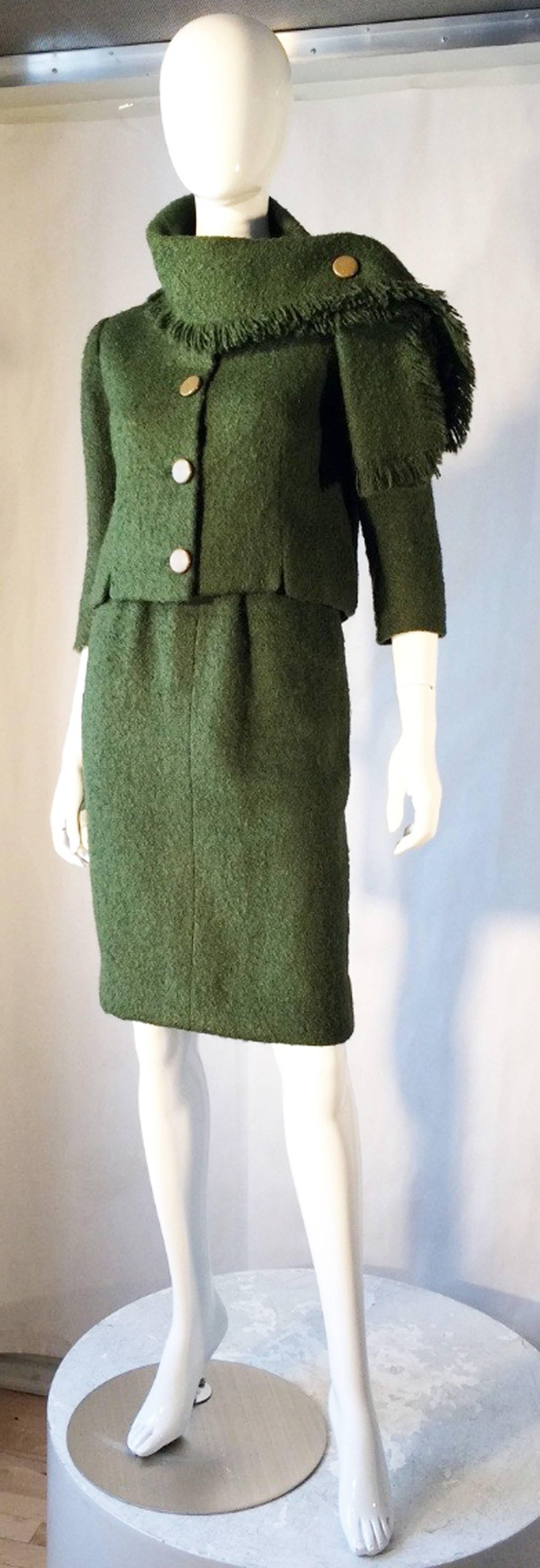 A fine and rare vintage Balenciaga haute couture skirt suit ensemble. Authentic numbered and documented item retains original hand written Balenciaga order receipt dated 1957. A wonderful shade of green 2pc. wool frise fabric items feature precision