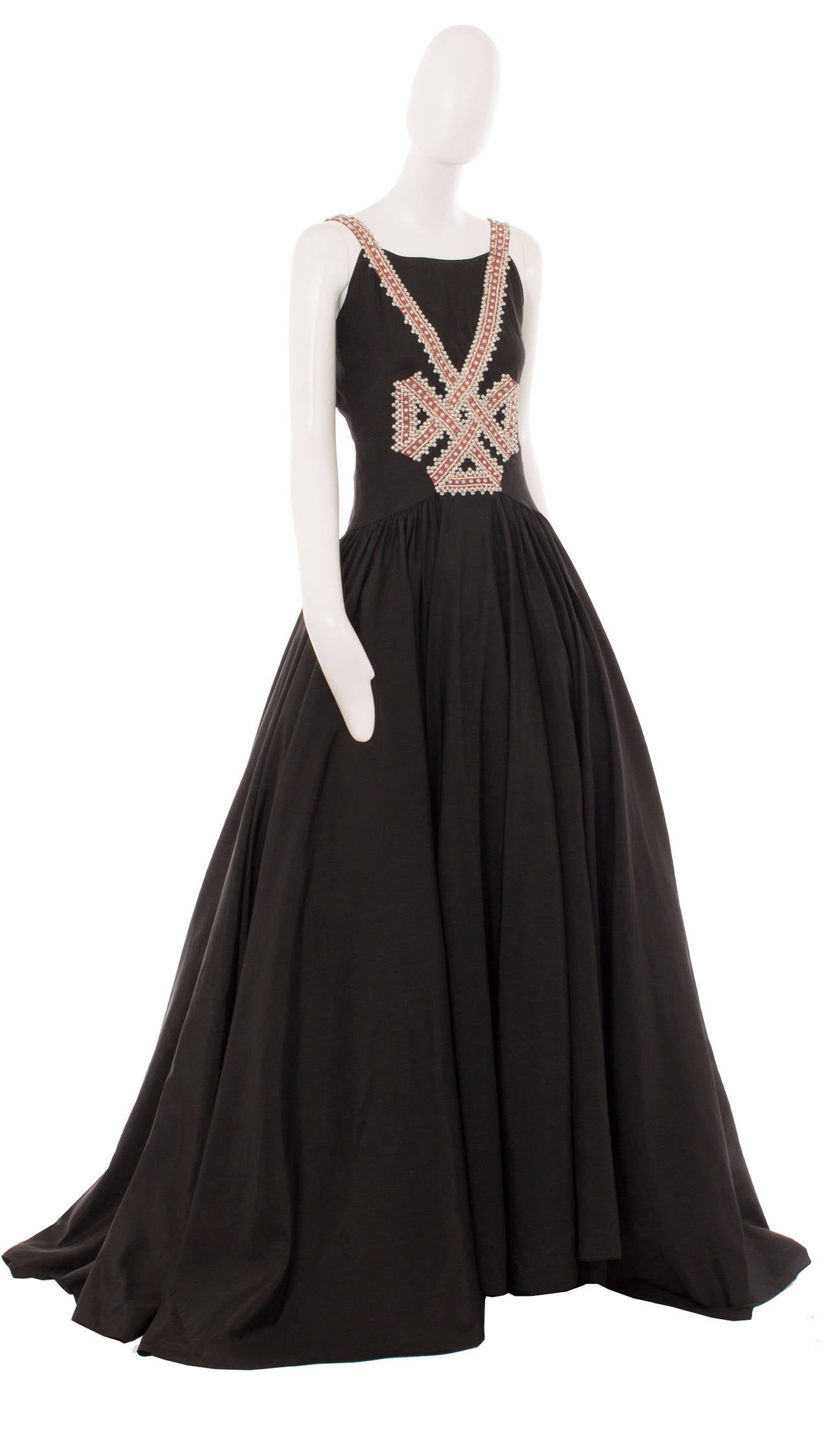 A simply stunning piece of haute couture by Lanvin, this black taffeta gown is the ultimate in red carpet or black tie dressing. The pink grosgrain ribbon detailing, embellished with hundreds of baby blue beads and gold sequins, creates a bow motif