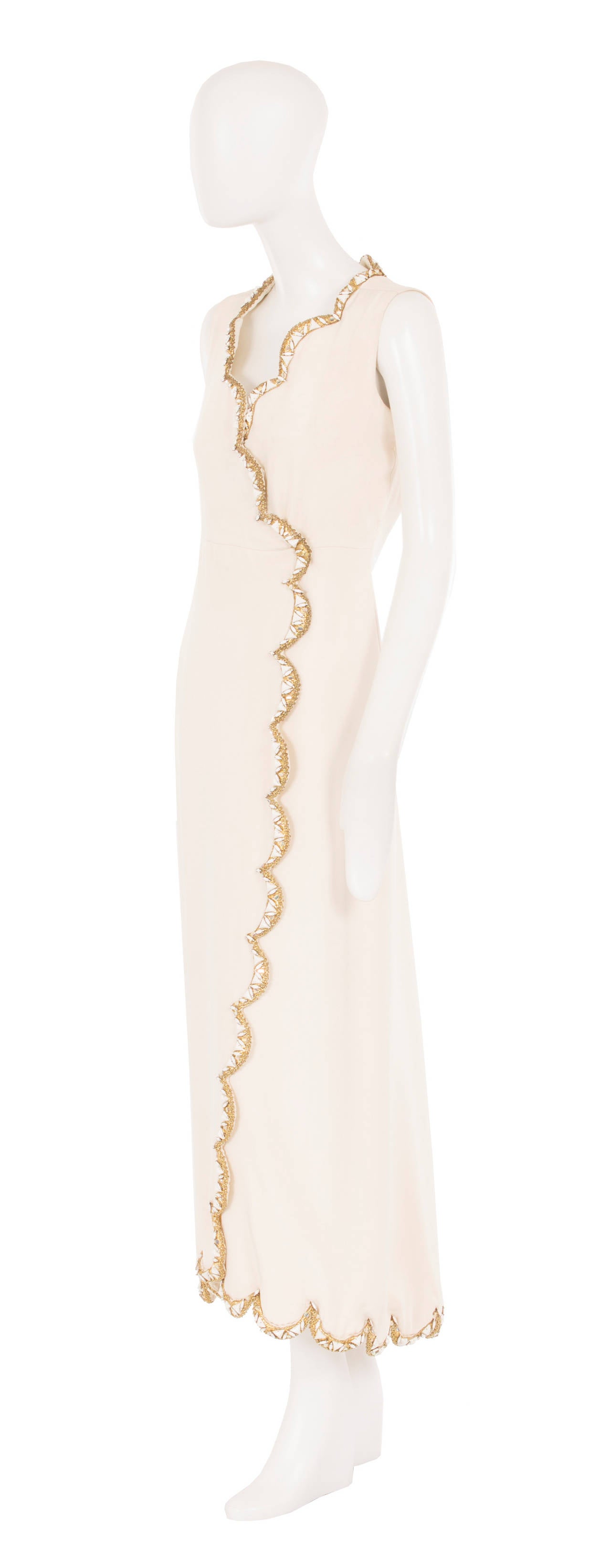 This Dior haute couture wrap dress is a super chic option for a special occasion or black tie event. Constructed in ivory silk, the wrap-style dress fastens with concealed press-studs to the front, and features gold and crystal embellishment to the