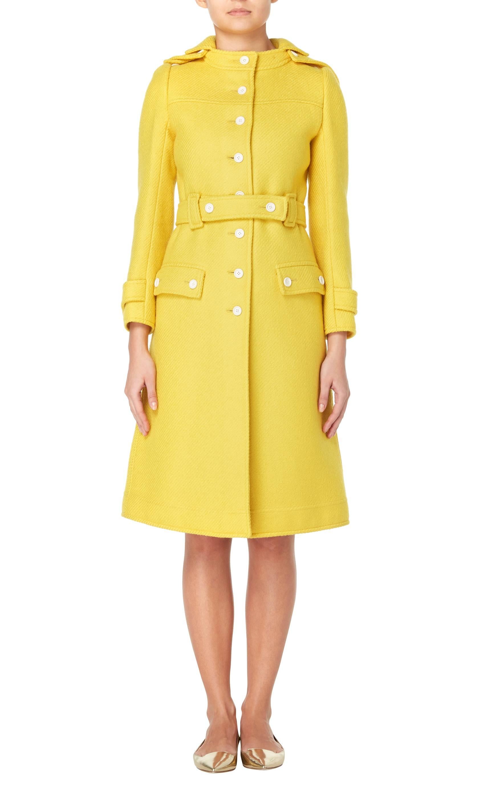 A great way of injecting some colour into a winter wardrobe, this amazing Courrèges coat will really make a statement. Constructed in canary yellow wool, the coat features a removable pointed hood and belt at the waist. With white plastic button