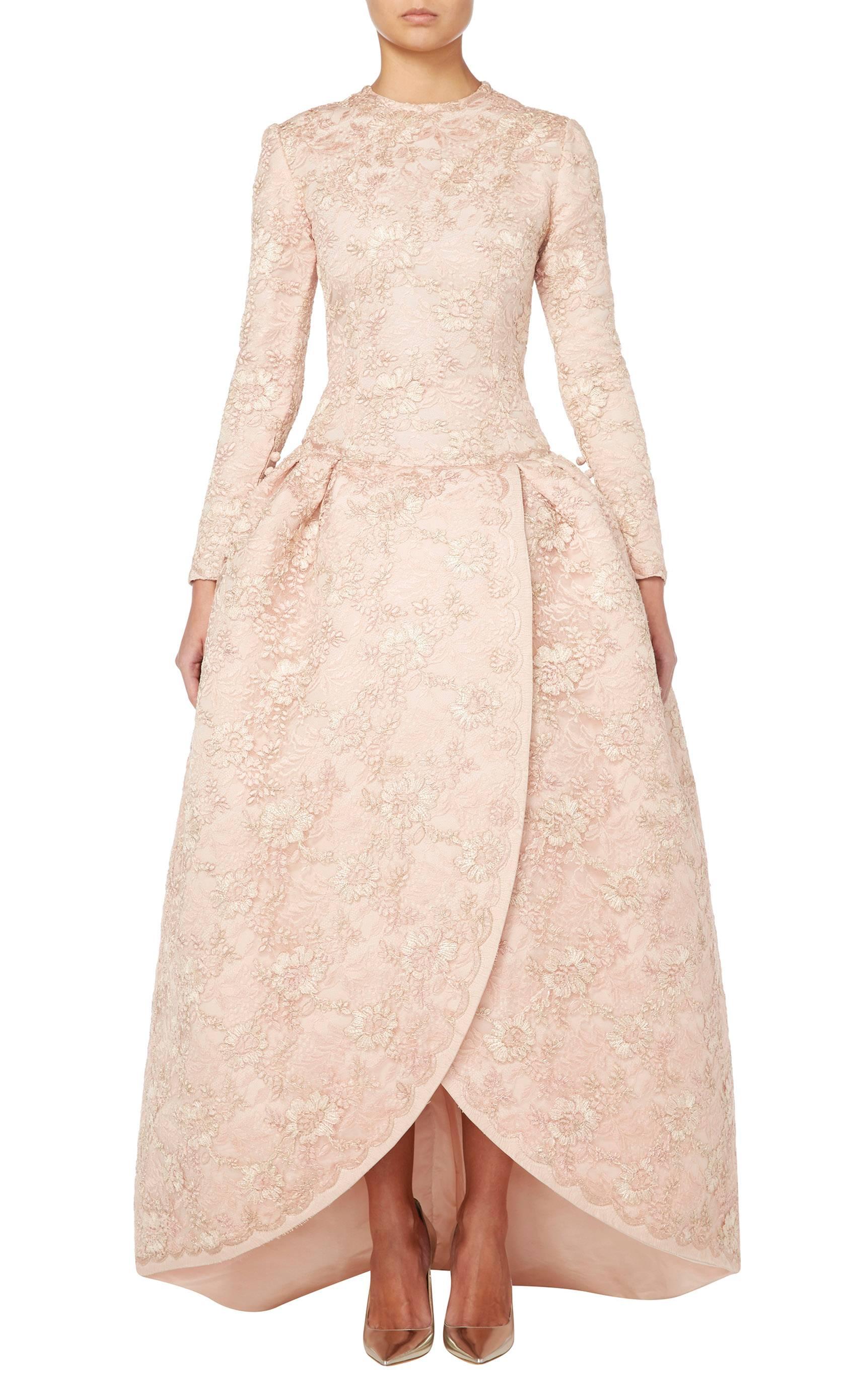 Founded in 1938, the house of Nina Ricci is famed for its elegant, delicate haute couture and this ball gown is testament to the refinement of the house. Constructed in pale pink, hand-made silk lace edged with metallic Lurex thread, the gown