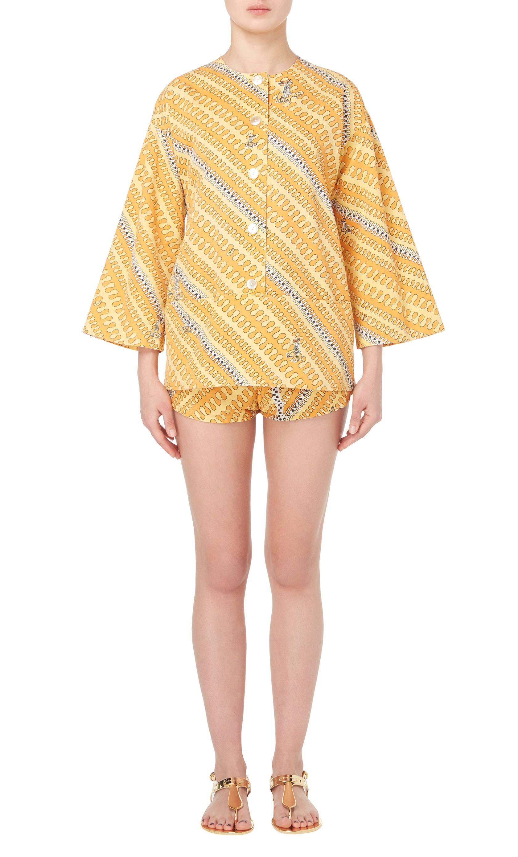A fabulous piece of Pucci, this cotton playsuit is the perfect choice for hot summer days spent at the beach or by the pool. Featuring a fun abstract print in shades of orange and yellow with elephant motifs, the playsuit has a boxy cut, with wide