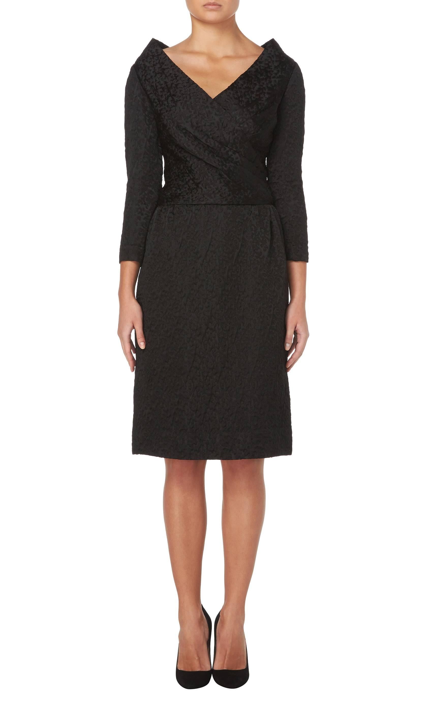 This incredibly chic little black dress by Hardy Amies will make a superb addition to any wardrobe and is perfect for everything from cocktail parties to dinners. Constructed in black cloqué silk, the dress has a flattering v-neckline, sitting high